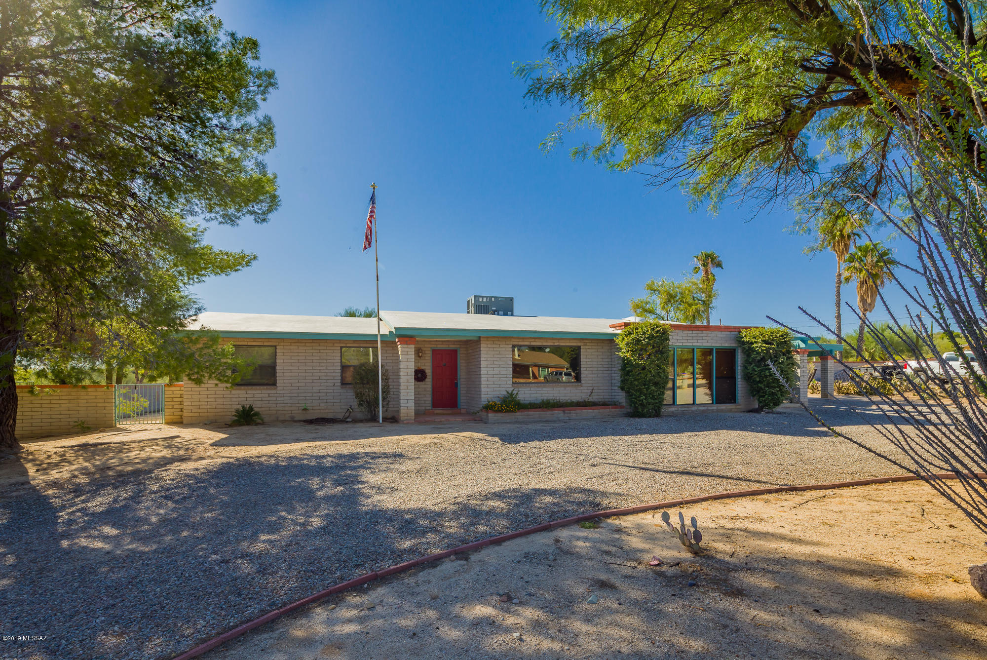 Next generation living without an HOA! Three master bedrooms in this large family home on over an acre of property. HVAC replaced last year, all windows replaced, remodeled kitchen that includes granite & stainless appliances, large family room with a wood burning fireplace, no carpet, all Saltillo, laminate & tile flooring throughout. Tons of shade on the extra large back porch, plenty of storage, large 2 car carport & completely walled in yard.