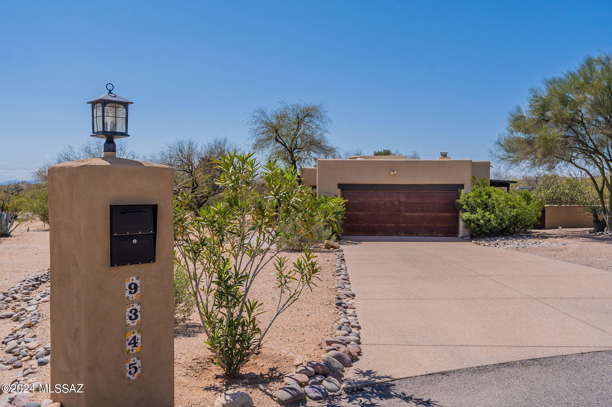 Range pricing: seller to accept or counter any offer between $650,000- $665,000.Beautiful 4 bed/2 bath home with north/south exposure, easy-care landscaping, and great views of the Catalinas! Step into the welcoming front courtyard of this well-maintained, single level home with an abundance of natural lighting and charm. Some special features include a beehive fireplace in the family room, granite countertops, crown moulding in the generously-sized bedrooms, and tile and wood flooring throughout. The laundry room has a built-in counter for folding or projects, and the walk-in kitchen pantry provides ample storage. Another fireplace can be found in the primary suite, along with a spacious walk-in closet and separate door to the backyard. The covered back porch overlooks a sparkling pool and lush natural lawn- a relaxing spot to enjoy the mountain and desert view