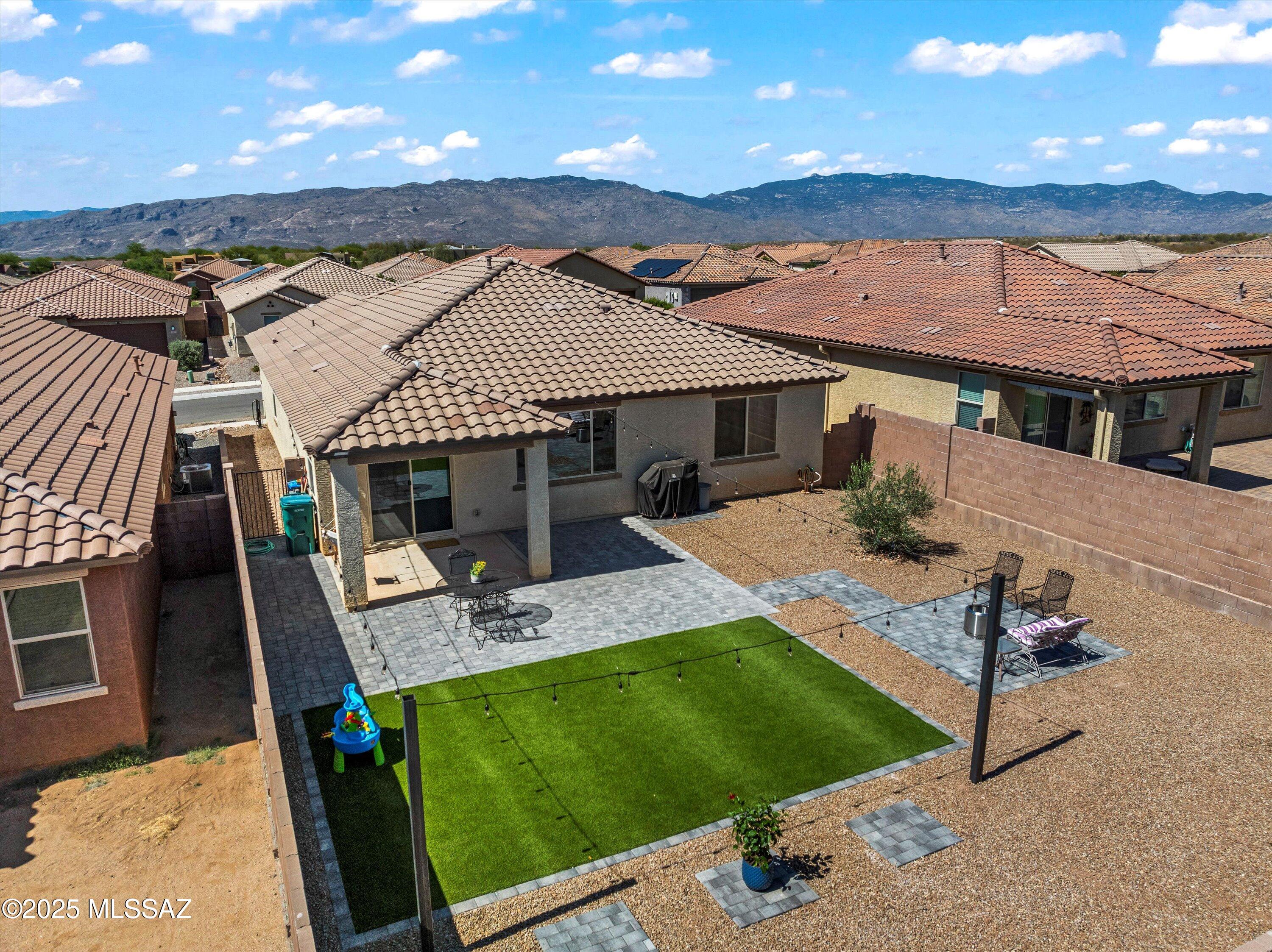 Seller will contribute $7,750, this could save buyer $427 per month off the mortgage payment. Ask for details!  A split floor plan for privacy, yet still with an open concept that offers plenty of natural light. 9ft Ceilings (Includes 8ft garage bay door & 8ft entry way door).  Step inside to beautiful wood like tile flooring that flows throughout the home, opening to the spacious kitchen and living room, yet there is a touch of comfort with carpet in the 3 bedrooms. The chef's kitchen boasts a large island perfect for gathering, and stunning quartz countertops among 42'' espresso cabinets that add a touch of elegance.  Enjoy the private backyard with New Turf, brick pavers, added to metal poles with cable overhead lights, Installed Irrigation in the backyard with a timer for trees.