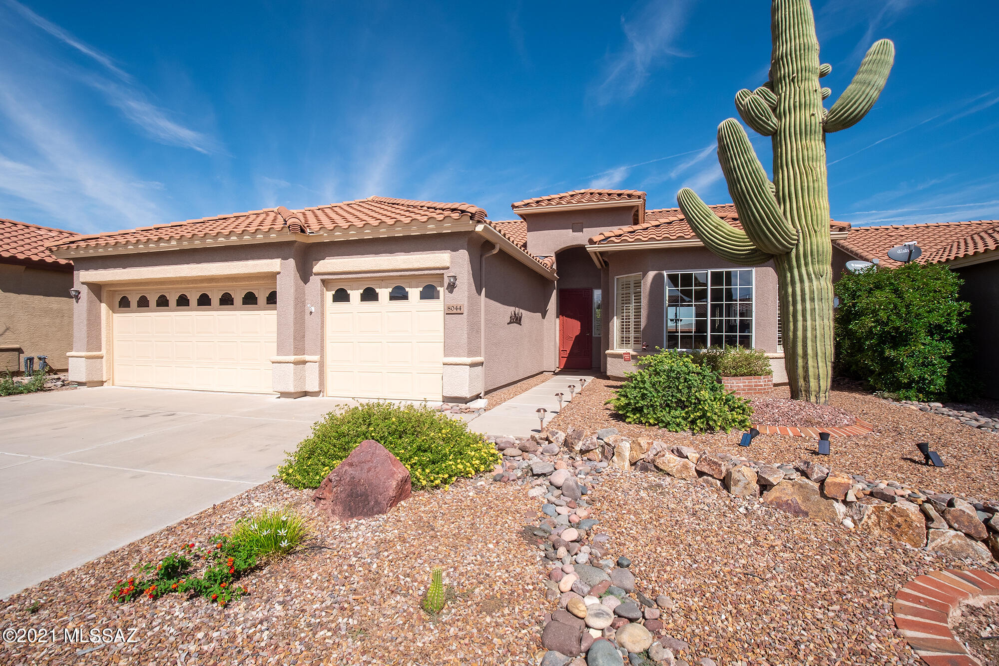 Kachina model with rare 3rd Car Garage along with beautiful mountain views. With 2000 SF, this is the largest model offered in the 55+ Community of Sunflower. Enter into the foyer & sense the airiness of the Great Rm & Dining Rm w/ picture windows to take in the spectacular view. 10' ceilings throughout. Kitchen is replete w/ granite countertops, backsplash, & slate appliances w/gas stove. The Bkfst area will give you hours of enjoyment. Den/Office area. Updates include: Roof Underlayment 7/19, Exterior Painted 2017, HWH 4/16, Watertec WS 3/20 & HVAC 5/17. Primary Bdrm is spacious & en-suite hosts a large shower & walk-in closet. Laundry Rm includes sink & W/D stay. Enjoy warm Tucson evenings on the extended paver patio with your own hot tub. Sellers will entertain offers $400,000-$425,00