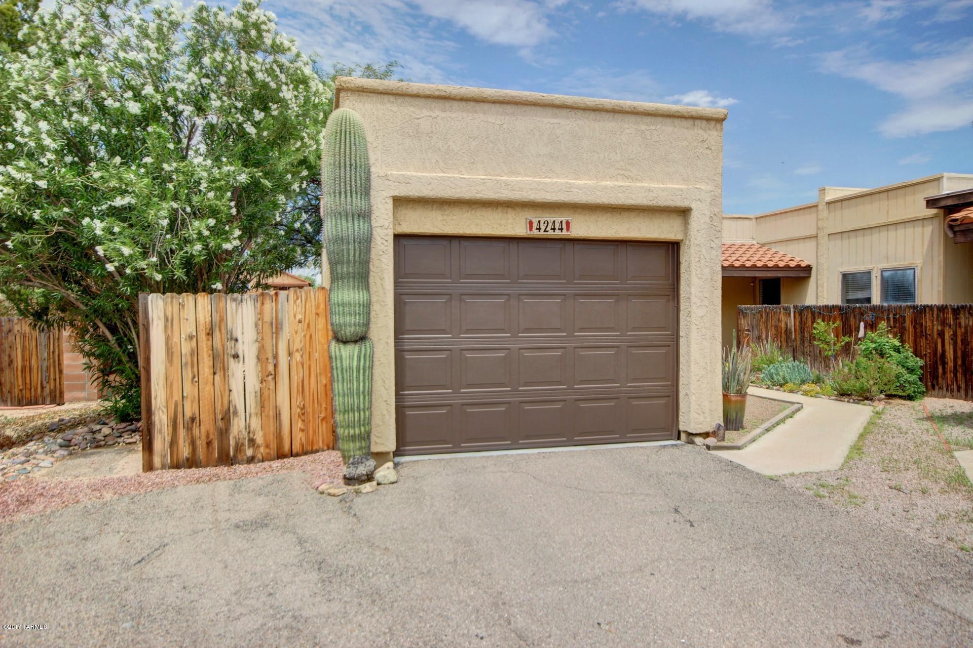 Lovely move-in ready townhome with open plan offering split 2 bedrooms and 2 bathrooms. No carpet here, laminate wood and tile, high ceilings, large finished storage room including washer and dryer and finished 1 car garage with cabinets.  Updated kitchen with cherry cabinets and refrigerator. The master includes a walk-in closet with a door to the backyard. The rear yard is wonderful for privacy and entertaining with mature shade trees and covered patio. HOA takes care of roof maintenance and exterior of the buildings, trash removal and community pool and spa.