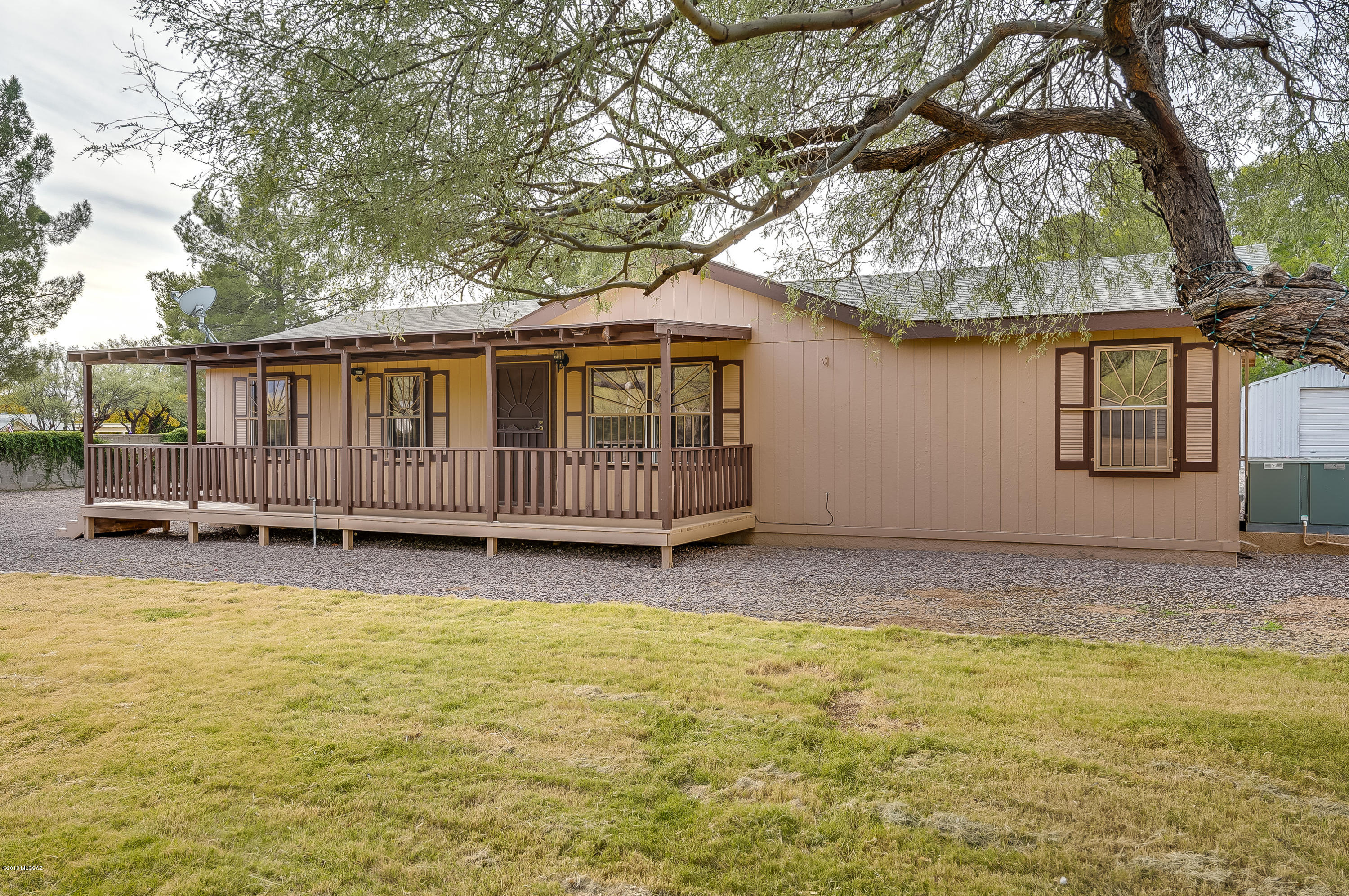 Beautiful, well-maintained home with large porch on front and back. Large master bath, 4 bedroom, wood laminate in living areas and carpeted bedrooms. MOUNTAIN VIEWS! Large low maintenance lot with big workshop and over-sized RV sized garage with additional 2-car carport.