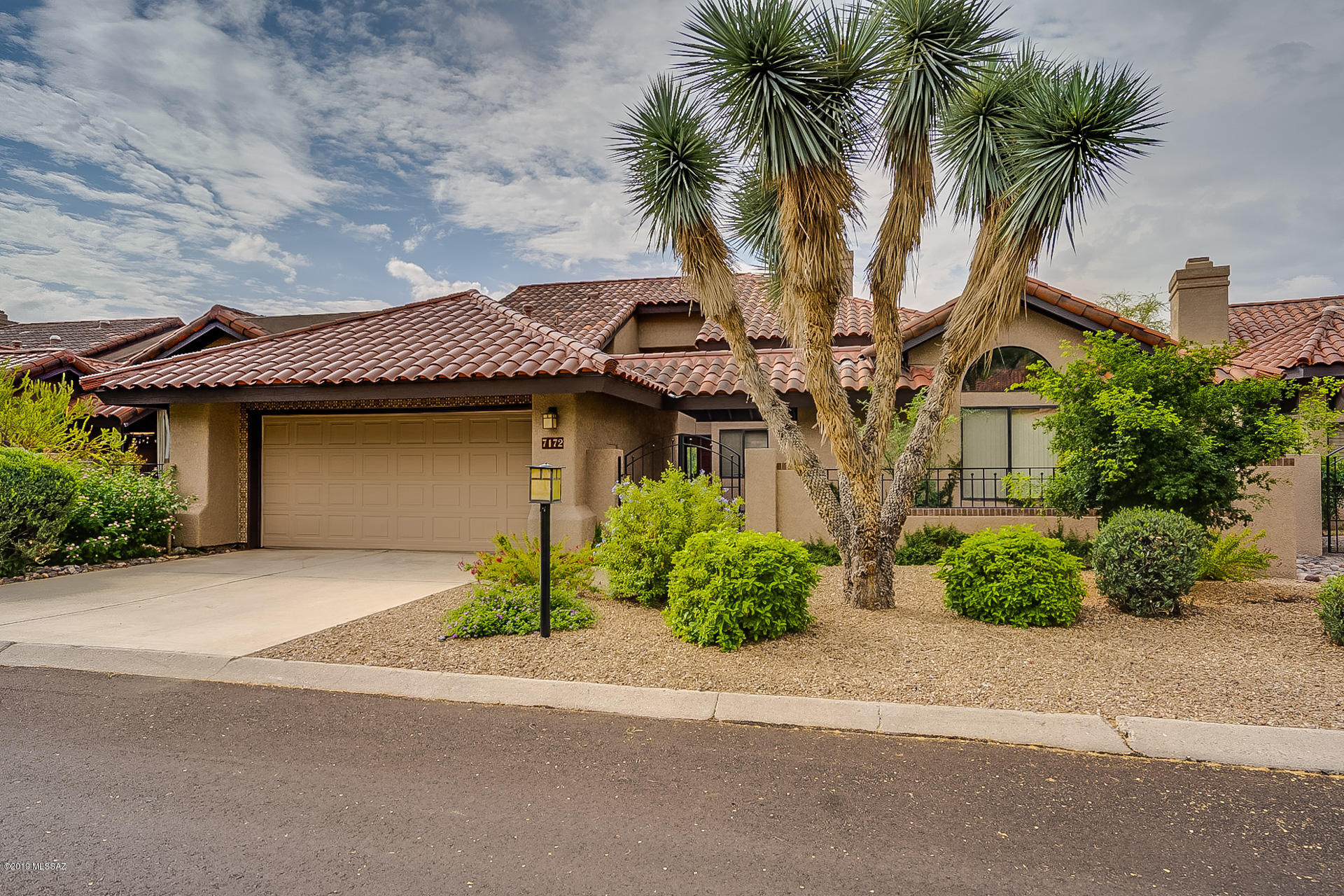 Move in ready townhouse in coveted Ventana Canyon Country Club Lake Estates. Courtyard entry into stylish floorplan featuring high vaulted ceilings with plenty of windows and natural light. Spacious and open great room and living room perfect for entertaining with a gas fireplace, and views to the backyard and golf course. Large kitchen with tons of storage, breakfast bar and upgraded appliances. Spacious owner's suite features access to the backyard, large bathroom with double sinks, soaker tub, shower and walk in closet.  Laundry room has a utility sink & cabinet storage. Additional room can be used as an office, playroom, or exercise room. Two car garage with plenty of storage. All appliances stay.