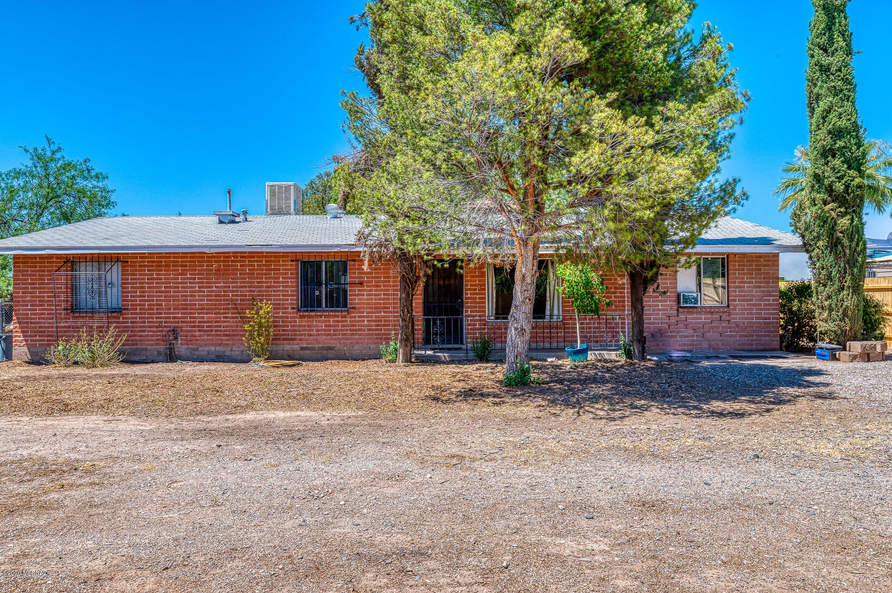 Welcome to this wonderful ranch style home. This amazing home sits on a 1/4 acre of mu zoning property and can have a variety of uses. The home offers a large kitchen with endless cabinet space. The living room offers a large wood burning fireplace. All guest bedrooms are sizable. The master bedroom offers a large closet and master bath completes it with jetted tub. Back yard offers lots of room with mature trees and in-ground fire pit. The property is in process of a split and both side are for sale at $400,000. The east property consist of a 2000 sq. ft. shop and 576 sq  office/studio. The miner split will not be completed until seller knows if buyers interested in both. The survey has been done and the east wooden fence line is the east property line.