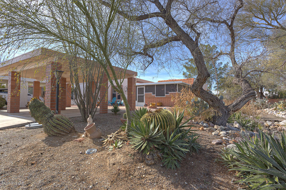 Looking for a winter retreat or a year-round home that's completely remodeled? This is it! Tiled throughout (laminate in the AZ Room); beautiful kitchen, wonderful screen room in the front, and sunny patio in back. This home shows like a model. Two-car carport, low maintenance landscaping, away from I-19 but conveniently located. Near several GVR facilities.