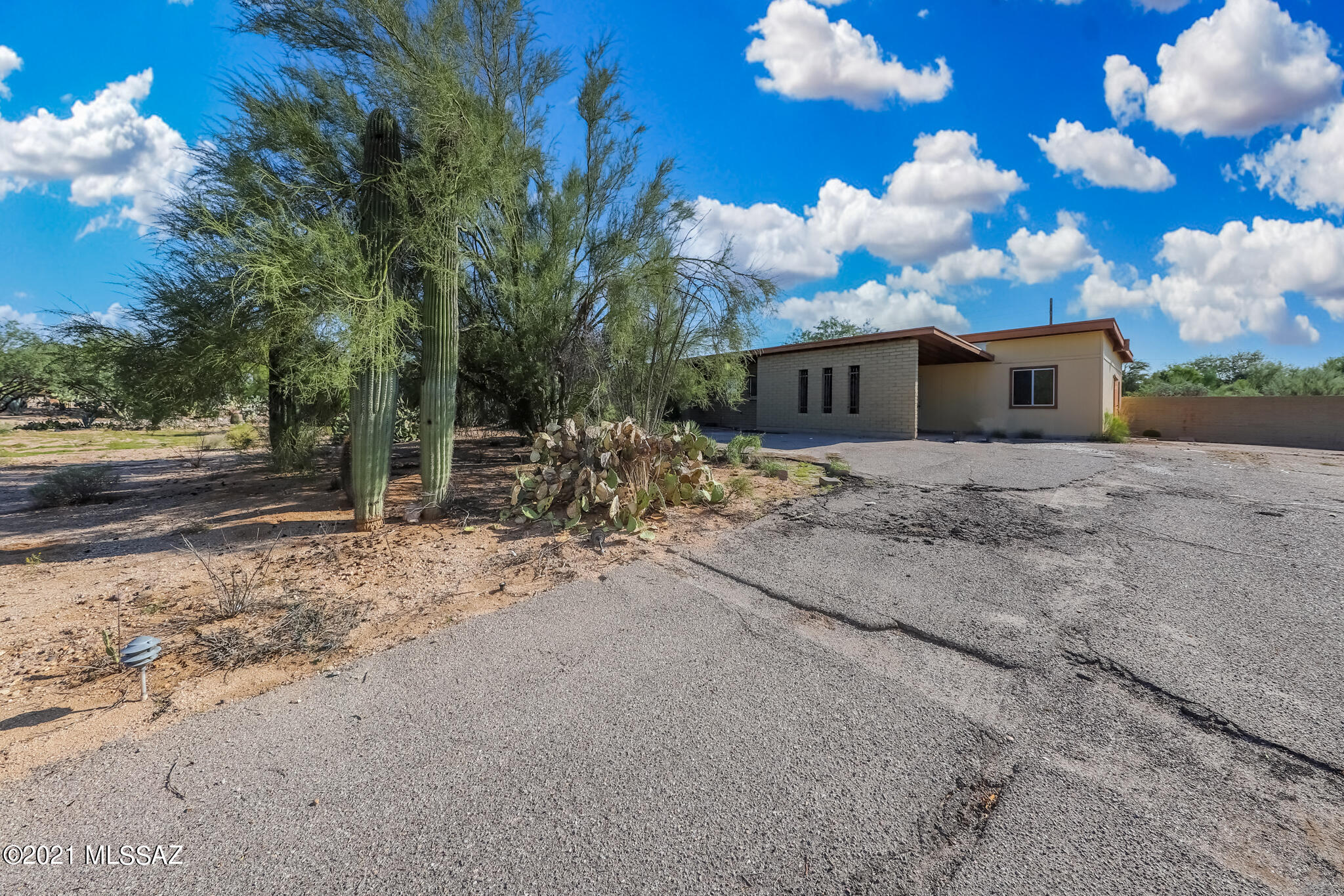 FIX UP OPPORTUNITY !SLUMP BLOCK 
CHARMING CASAS ADOBES AREA ESTATE! RANCHOS DE LA CANAD HOME HAS ENDLESS POSSIBILITIES 
HOUSE IS 1782 SF 3 BED 2 BATH WITH AMAZING VIEWS OF PUSCH RIDGE. ADDITIONAL PERMITED 644 SF SHOP WITH SEPARATE 210 ELECTRICAL & 10' CEILING READY FOR NEW MINI SPLIT, TURN SPACE  INTO GARAGE, RV GARAGE OR GUEST HOUSE
NO HOA! READY FOR ITS POTENTIAL !  
BIDS FOR ROOF AND HVAC ATTACHED
2 STORAGE OUT BUILDINGS .