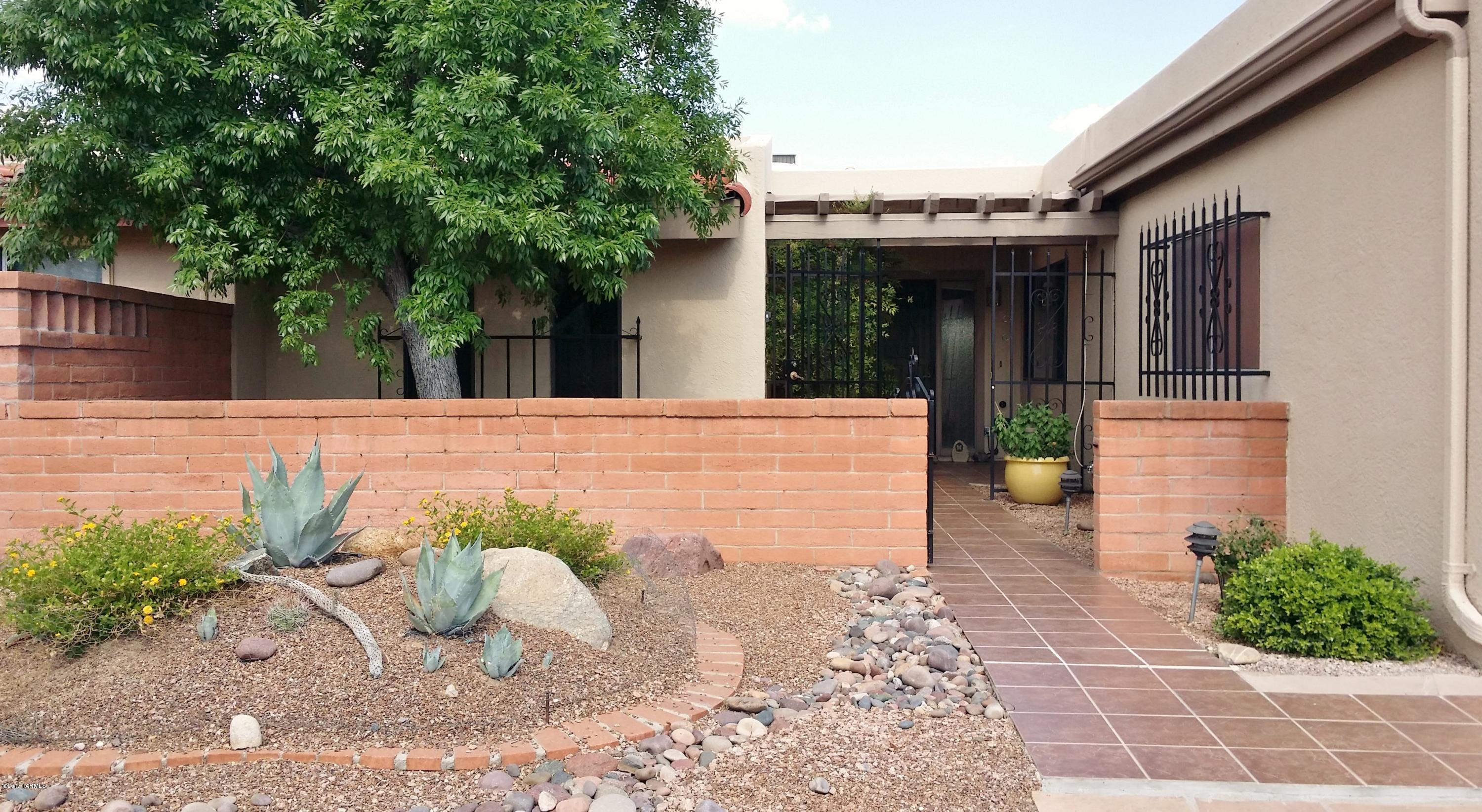There are so many special things about this townhouse. The nicely landscaped front has a shade tree and an enclosed courtyard. Inside the front door you are drawn to the large living area with a wall of sliders framing the private backyard with a view of the Santa Ritas topping the wall. The living area has a kiva fireplace surrounded by a brick wall and a large dining area perfect for entertaining. Around the corner you find the multi-purpose family room to use as an office, a den, or a TV room. In the kitchen, there's quartz counter tops, large pantry and pullouts in many of the cabinets. There's a laundry room with storage and a 2 car garage. The master bedroom & bath are sunny and roomy. New dual pane windows & a screened AZ room, too. A bonus is 16 acres of common space with trails.
