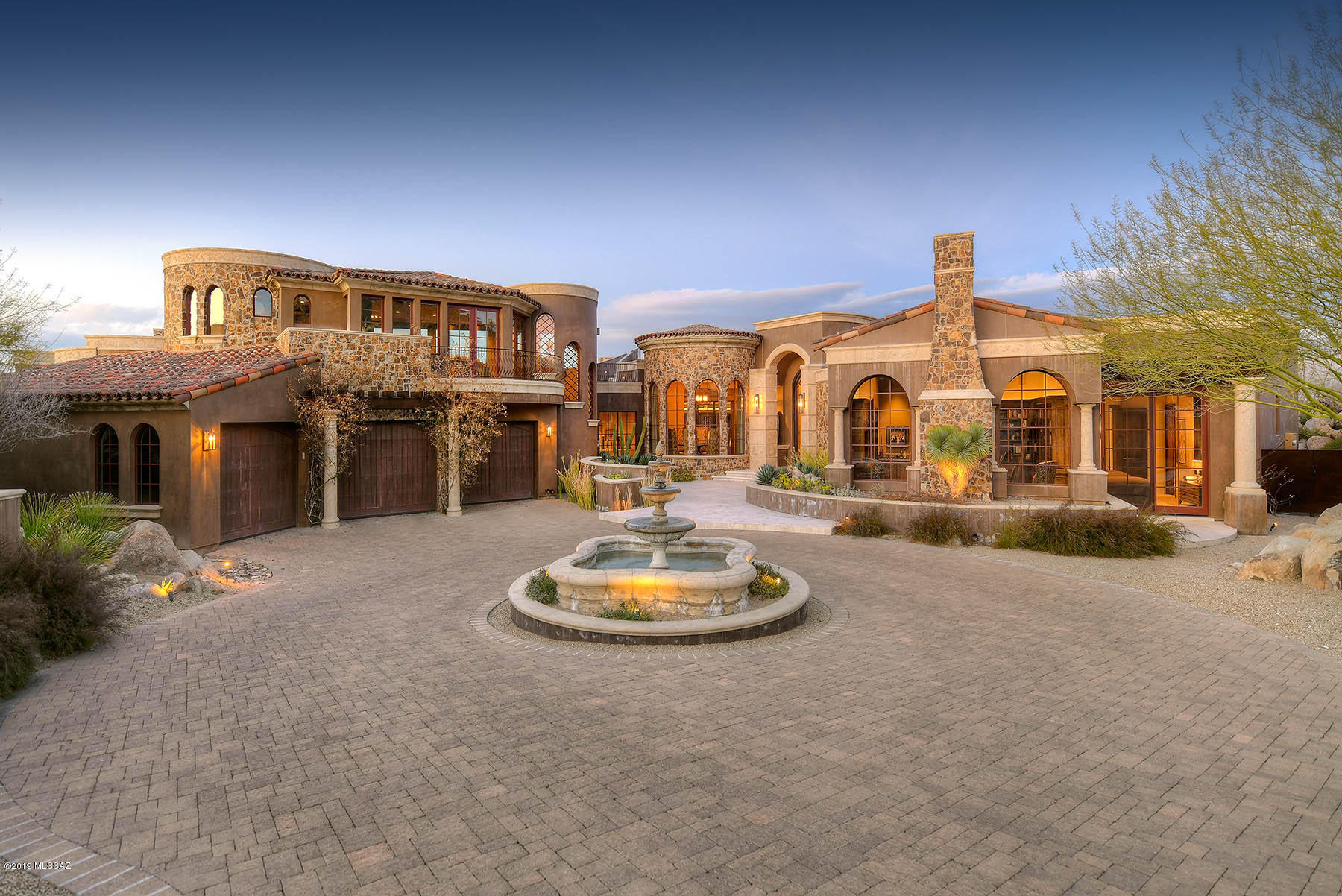 Storybook Modern Day Palace positioned meticulously on 1.5 Acres of beautiful desert landscape. Rock formations performing as unique picturesque walls of privacy yet subtle enough to offer endless views.  Marc Soloway & Lori Carroll have created a truly seductive architectural masterpiece. 
Artisan handcrafted Brioche Walnut with custom distressed flooring in office together with FP, library, wet bar & entertainment center
Massive front door presents the majestic foyer looking out at the custom ceiling with cove lighting. Magazine featured award winning kitchen and bathrooms. Staircase to loft media room crafted from Tivoli Walnut Slab material. Showcase up to 600 bottles in the temperature controlled wine room.
Retreat to one of multiple outdoor spaces of true respite featuring pool, s outdoor fire pit and upper deck cocktail lounge. Too many features to elaborate. See attached document with list of features. Enjoy living in one of Tucson's most Exclusive Country Clubs. Stone Canyon Continuously ranks in the top 100 in the country. Agent available to tour home and amenities.