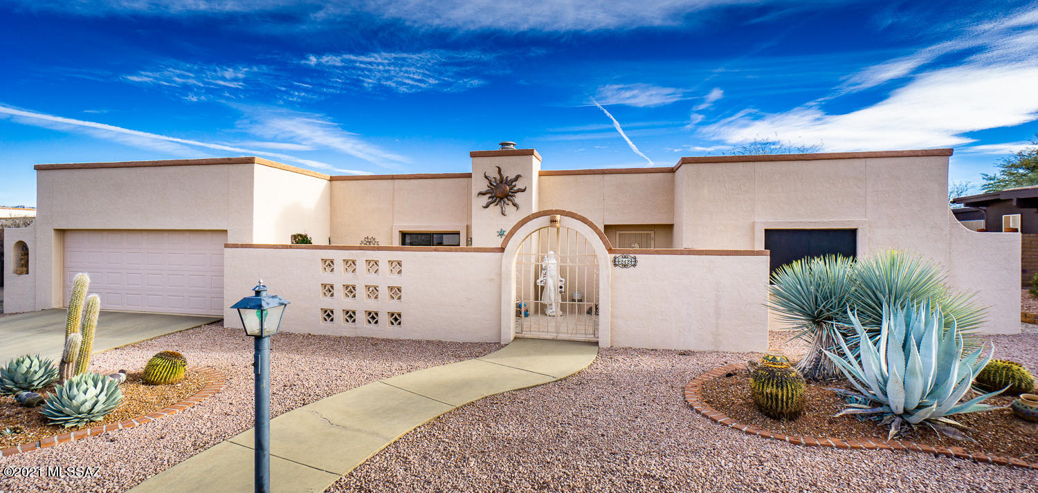 This home is one of the few homes on Chuparosas with a mountain view! The front entry greets you with a surprisingly private courtyard. With Mexican tile throughout. The front room with the fireplace can be a flex room-either as a formal dining room or as a living room. The updated kitchen has granite counters, white cabinets and plenty of 'appliance garages' to store your kitchen items. The great room includes the current dining room for easy entertainment and off that area,' belly up' to the wet bar with seating, back bar and lots of bar storage. The master bedroom has a separate space for an office/studio/sitting room. Pass through the laundry room on the way to the garage, then just off the garage is a separate workshop or storage area w/deep sink and Easy Water system. Furniture SBOS