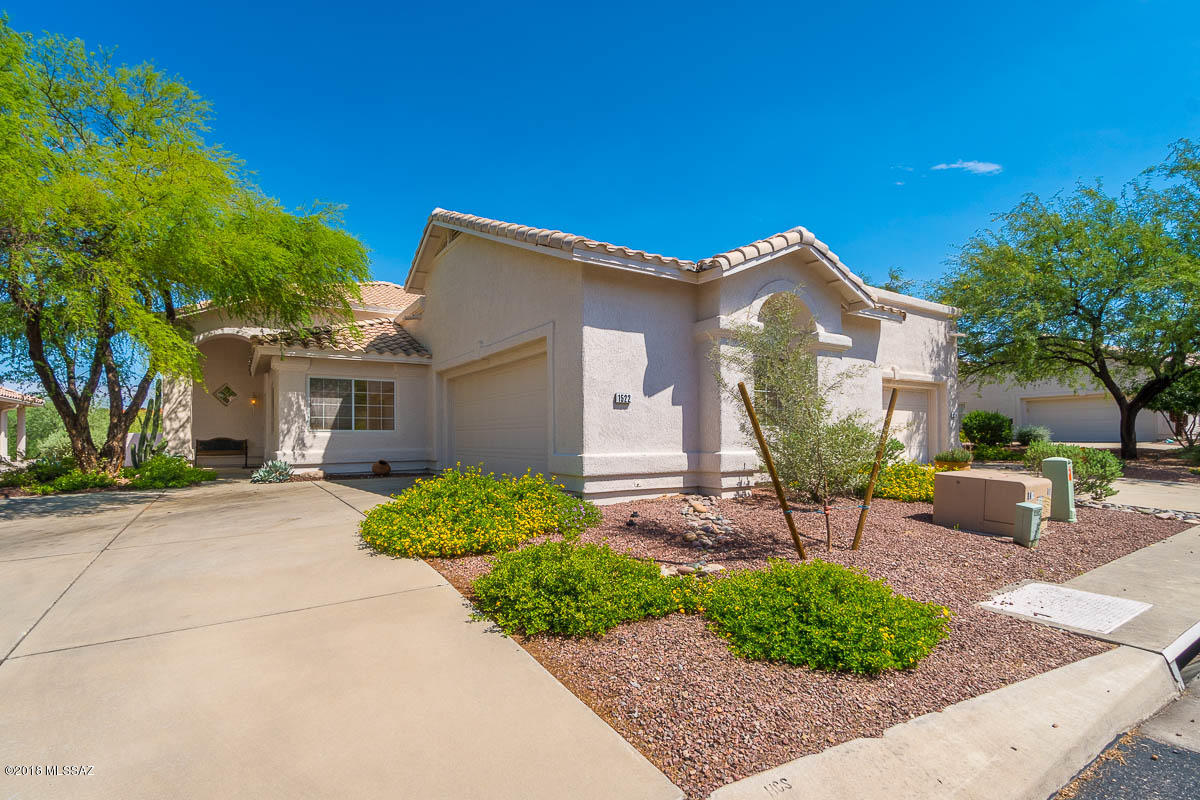 An immaculate Carmel Pointe Townhome. Lovely gated community conveniently located in the heart or Oro Valley.Just North of El Conquistador golf and tennis club. This townhome backs up to the golf course and private area. A corner unit. Soaring ceilings and popular open concept. Split bedrooms with large closets. Great room with fireplace.Plantation Shutters thru out,Granite Counters. Just an awesome floorplan that has been remodeled extremely nice. 2 car garage. Covered patio that backs up to privacy. A must see.