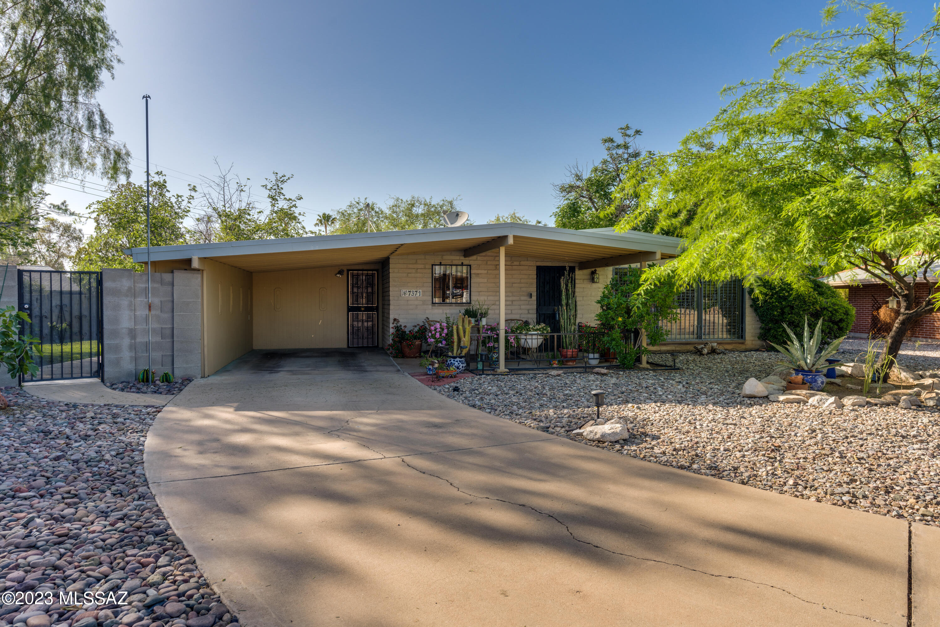 Welcome to this beautifully kept 3BR + Den,2 BA home with custom touches. Bonus 520 SqFt Workshop perfect for all your hobbies and projects. The kitchen is a cook's dream with custom Alder cabinets, Granite countertops, and stainless steel appliances. Kitchen cabinets with pull outs including wine rack, making this an efficient space. The Den is a stunning library, complete with plenty of shelves and a seamless connection to the living room. Throughout the home, you'll find new ceramic tile. Beautiful private yard with citrus trees + there's even a rainwater collection system in place. Tons of storage in and out. Come take a look at this gem! Evap cooler & Rainwater system As-is condition (Seller has not used). Chiminea off porch is included as well as compost & wood on table for chiminea.