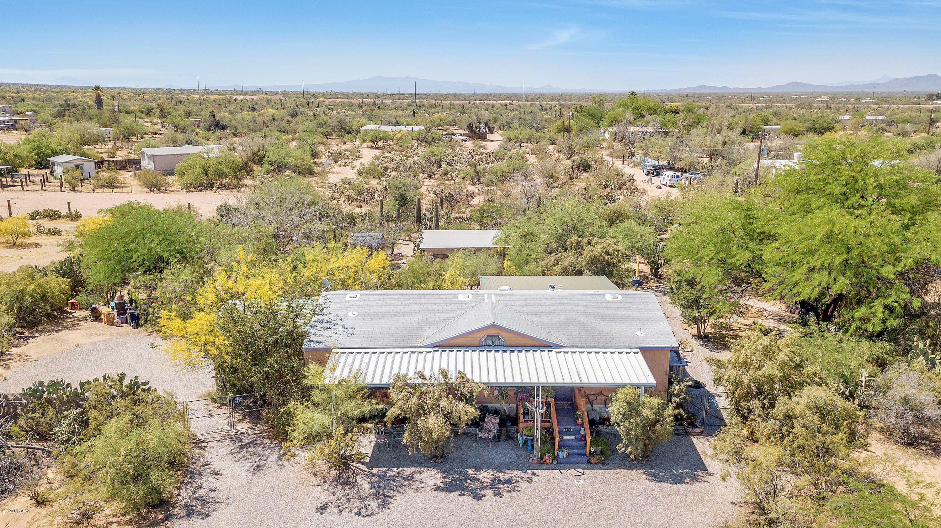 This wonderful artist's oasis in Picture Rocks features a Palm Harbor Energy Medallion, Split floor plan, 3 bedroom, 2 bathroom home which sits on just over an acre. the beautiful yard includes over 75 trees along with a dozen saguaro cactus, a fish pond, and elevated gardens surrounding this home. The expansive yard includes a 625 square foot workshop with an evaporative cooler, an 8x8 greenhouse/storage, and a 7x7 storage shed. The Picture Rocks Community Center Swimming Pool & Park are 5 minutes away. Come see this truly unique and captivating home today!