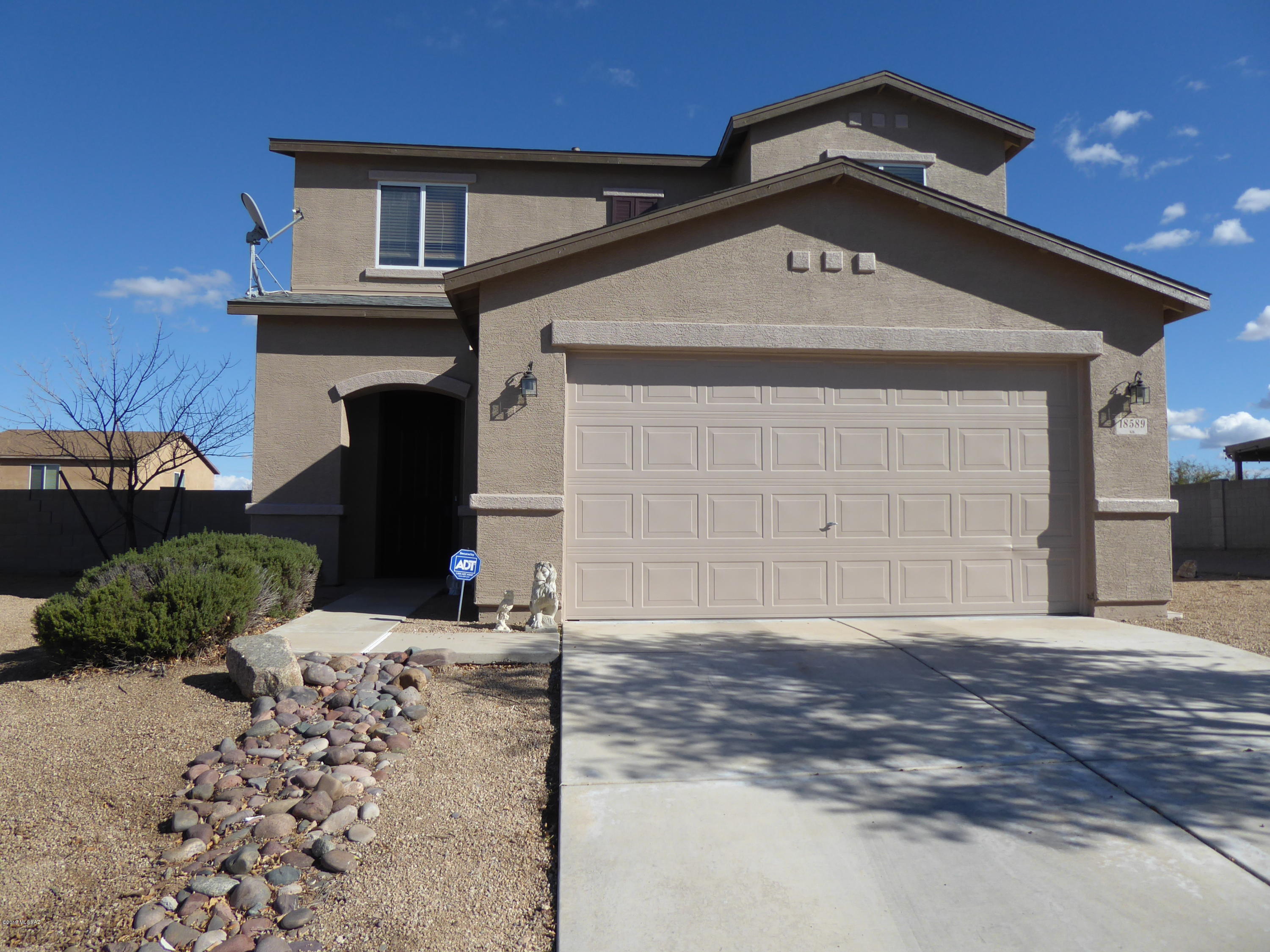Large home at a great price! Spacious airy floor plan features large great room and a formal dining area. Spacious open kitchen with breakfast bar, lots of cabinets and storage with laundry room off kitchen. Upstairs this home features 3 large bedrooms (including a master suite) and a loft/game room. Spacious master bedroom suite has GREAT views of the Santa Rita Mountains and a walk-in closet. Master bedroom features a double sink vanity. The HUGE backyard with covered patio is a blank slate ready for your design plans, pool, spa, BBQ center?  There's room for them all! Exterior & interior freshly painted!