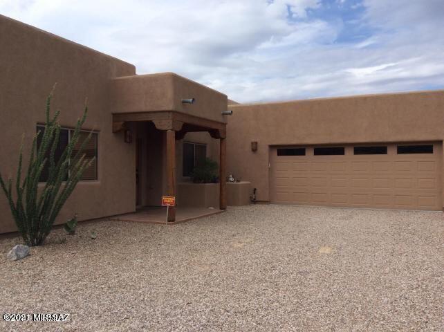 Custom built Santa Fe featuring clerestory windows - wood beams - and scored concrete floors. Bedrooms are carpet. Open floorplan. Kitchen has tiled countertops and stainless appliances. Formal Dining Room PLUS den. Master bedroom is large and has huge walk-closet. Master bathroom is custom and has walk-in shower. Front bedroom could easily be an office. Split bedroom plan. Very large laundry room with custom built in laundry bins. Oversized garage with plenty of storage space. Covered patio in back yard plus a separate dog area PLUS a garden area. This home sits back off street and has long driveway. Easy access to I-10. Call today for an appt.