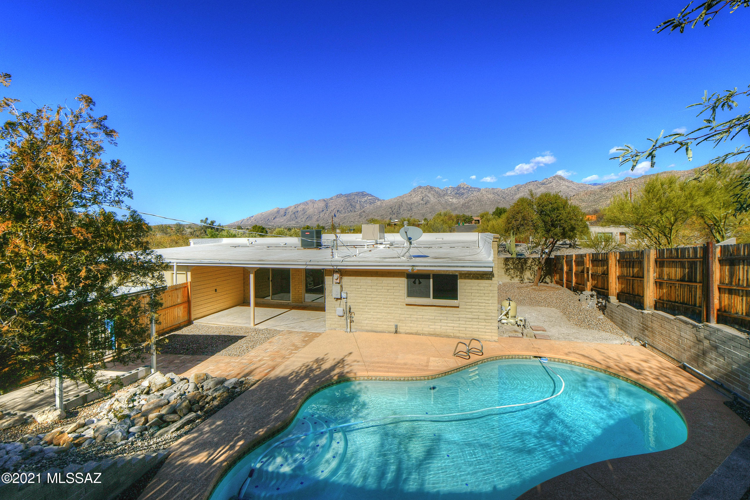 Beautiful, updated home in Northeast Tucson. No HOA!!! Enjoy breathtaking mountain views from living room window. A newly plastered pool equipped with a brand new pool pump. Great sized covered patio, perfect for entertaining. Brand new 2020 A/C, brand new grey plank tile in common areas and new carpet in bedrooms. New sparkling windows throughout. Fresh interior paint! 2 car garage with brand new garage door. 200 sq foot A/C unattached studio... perfect for an art studio, guest bedroom, etc. A must see!!