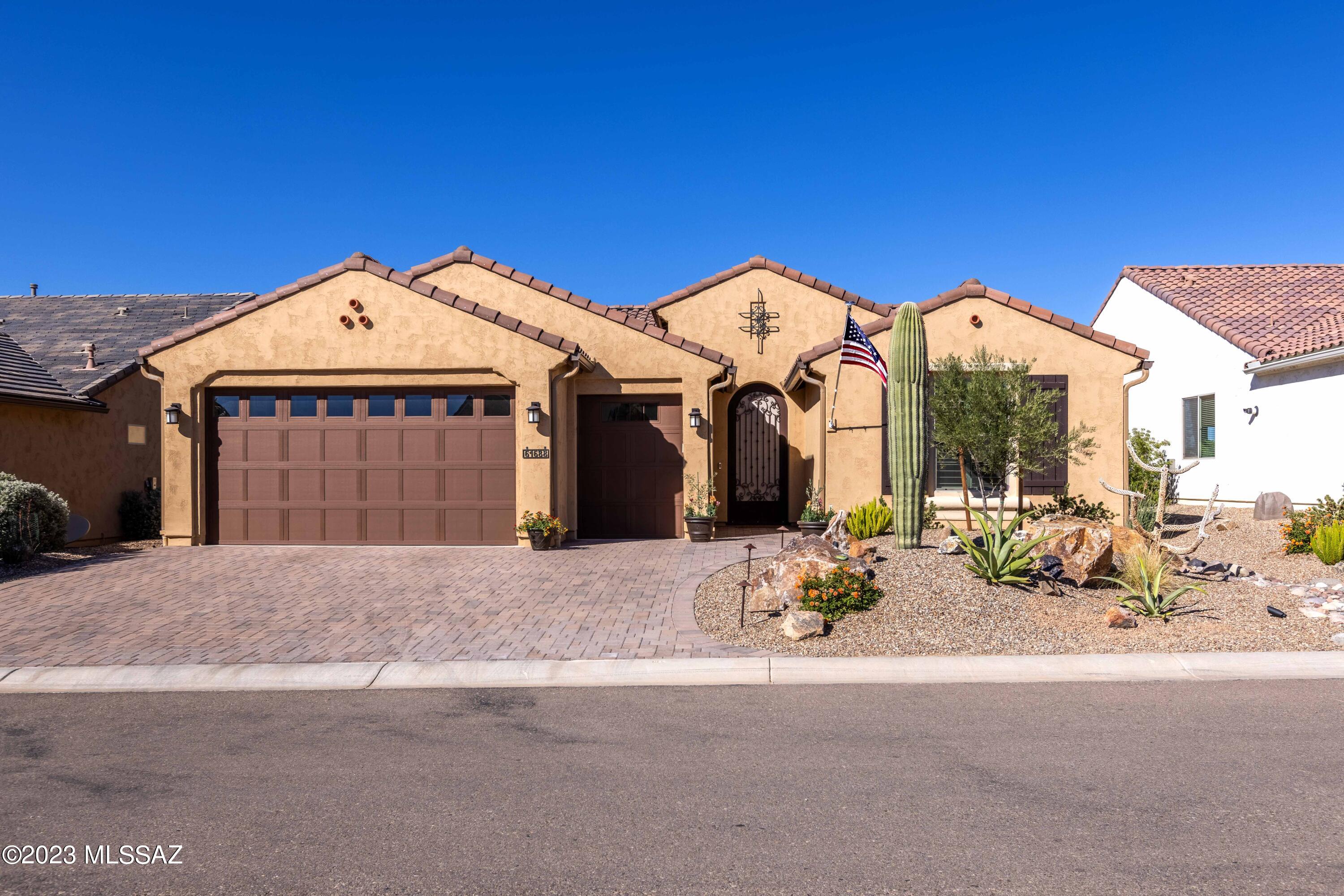 Better than new, 2021 Hermosa in SaddleBrooke Ranch lightly used by Snowbirds. Affordable Resort living at its best is right here.  The backyard borders a large common area Arroyo where you will enjoy outdoor living, featuring an expanded paver patio with deep covered area, water fountain, artificial turf and 2 gas line stubs. The yard is fully enclosed with a Wrought Iron fence and side gate.       2.5 car Garage: 4 Ft extended length, extra LED lighting, fully insulated, extended line for air compressor, TV bracket, storage shelves, man-door to side yard, fold down craft table, workbench with tool peg board. Portable shelves and desk can be included. 
''read more'' The bright and open Great room has wood-look wide plank floors that run through the common areas. High quality surround sound ceiling speakers. Extended laundry room with extra storage. Plantation shutters and pleated shades with custom drapery. Kitchen with center island, gas cooking, granite counters & full height back splash, stainless appliances & soft close cabinets.   
9' and 10' ceilings with 8 Ft interior doors. Rheostat controlled lighting in kitchen, great room, dining, and patio. 
Ultima Water conditioner. Rain gutters.  
The impressive landscape design includes a variety of desert plants, 2 Saguaros, boulders and 3 zone drip system. Paver driveway.  House is set back to provide a 5 Ft longer driveway.
See more detail in documents section.