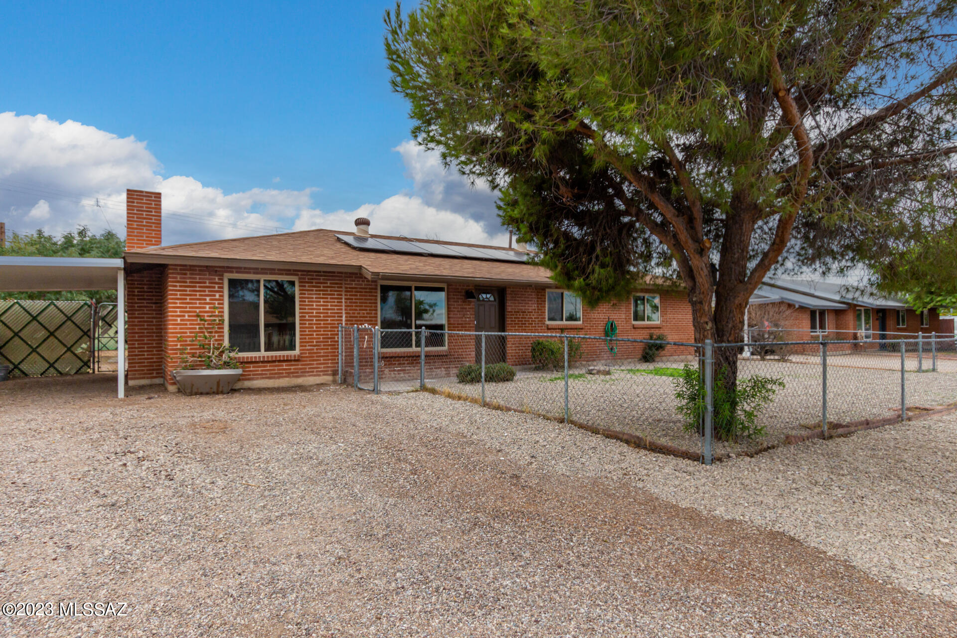 SOLAR IS OWNED!!! This charming single-level property in Tucson is the perfect place for you! Discover a harmonious interior showcasing generously-sized living areas, tile flooring, & fresh soothing palette throughout. You'll also find a cozy fireplace great for relaxing during chilly winter evenings! The spotless kitchen boasts pristine white shaker cabinets & sparkling stainless steel appliances to make meal prep a bliss. End your busy day in the comfortable primary bedroom comprised of soft carpet in all the right places & a private bathroom. Discover a fantastic backyard ideal for your gatherings!