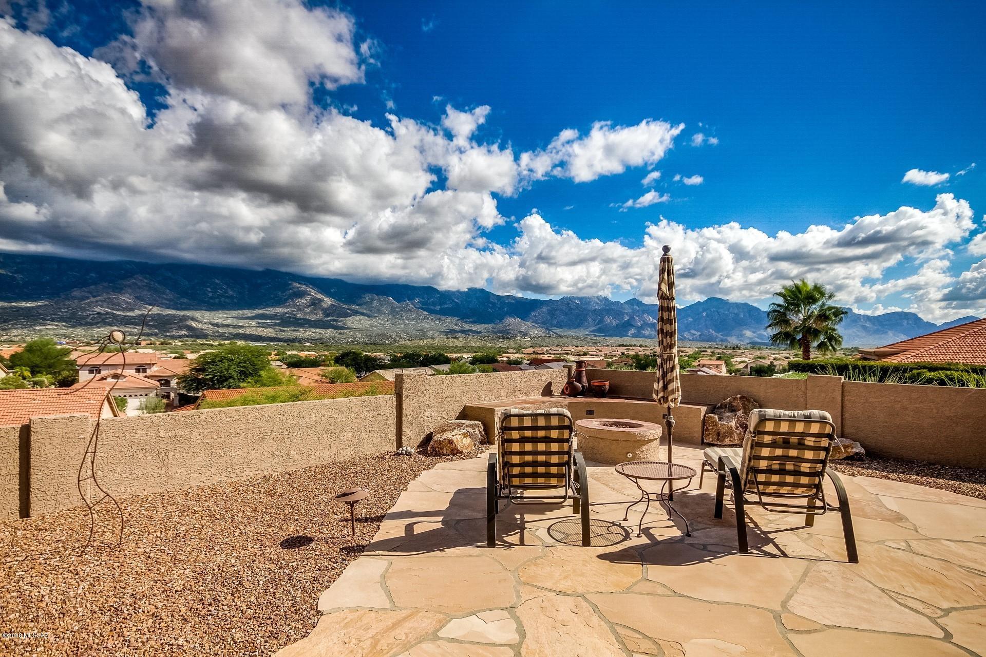 180 Degree Mountain Views from this Beautifully Appointed Dakota Model with Guest Casita! The numerous interior features include granite kitchen counters, SS appliances, Hickory cabs, pull outs, granite topped serving buffet, neutral tile, completely remodeled bathrooms, decorator paint throughout, Murphy bed in Casita, welcoming front porch with custom designed screens & flagstone, 4' garage ext. with extra lighting & epoxy coated flooring.  Exterior boasts amazing Arizona Room, extended flagstone patio with tile topped seating area, gas fire pit, shady Ramada with BBQ & elevated hot tub. Perfect backyard for entertaining! Home exterior repainted and patio roof recoated in 2018. Make this lovingly well maintained home yours and start enjoying the SaddleBrooke lifestyle!