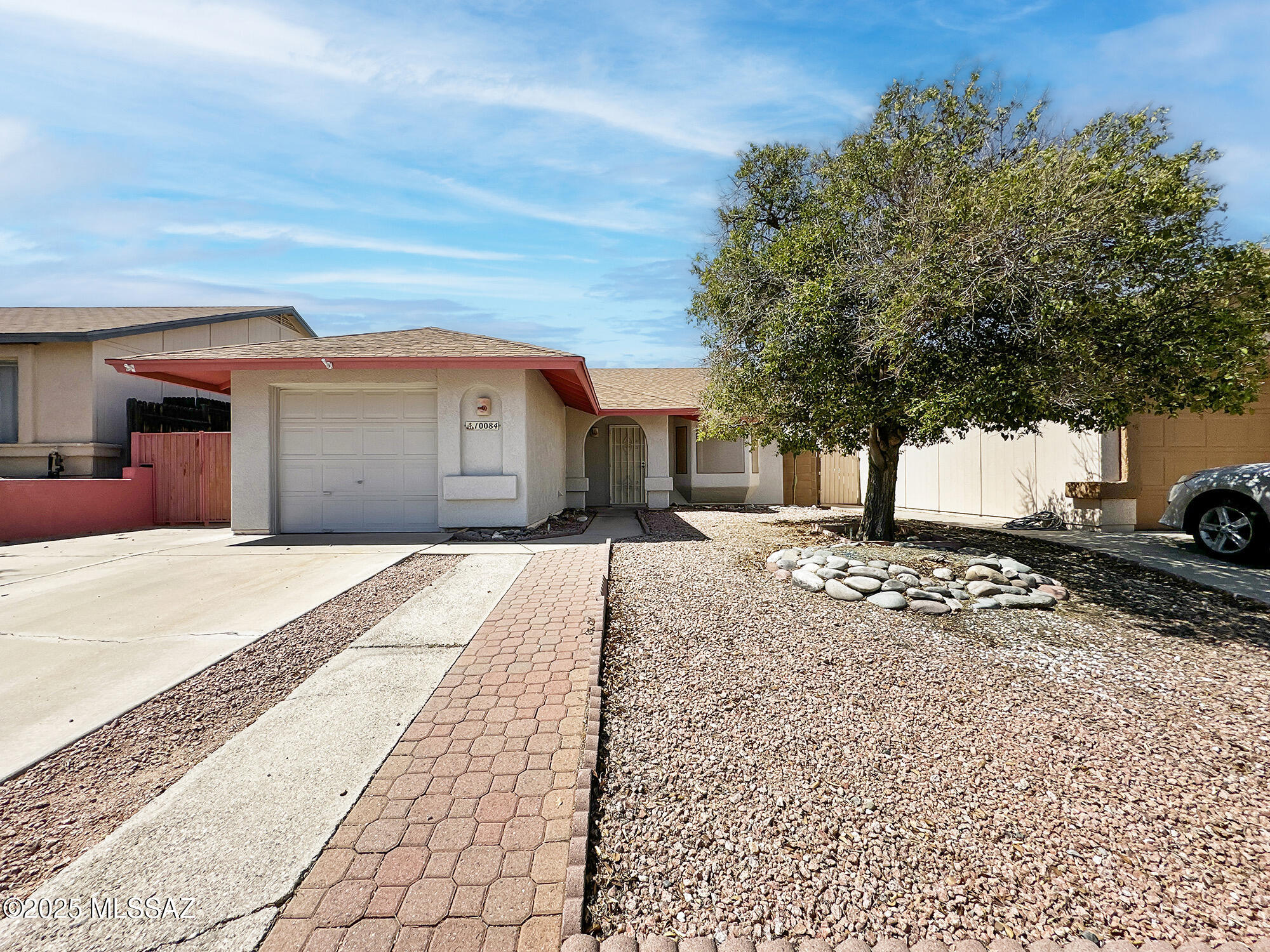 Check out this charming 2-bedroom, 2-bathroom, standalone home in the highly desirable Reddington Hills neighborhood, conveniently situated off the Houghton Corridor. This home features 1088 sq ft of living space, a family room, a living room, tile flooring in the main areas, and wood laminate bedrooms. The functional kitchen opens to the family room and dining area, separated by bar seating. A cozy wood-burning fireplace enhances the character of the living space. The vaulted ceilings add to the spacious feel, while a newer HVAC system ensures modern comfort. Step outside to enjoy your covered patio, which boasts lovely brickwork and a fruitful citrus tree on a drip irrigation system ready for any additional greenery you may want to add. The backyard offers plenty of privacy and potential for entertaining needs. Additional features include a 1-car garage with extra storage space for cabinets. You'll also benefit from a low-cost HOA, which provides access to a community pool, ramadas, or take a stroll to the nearby park and sports facilities. This gem is waiting for its new owner. Schedule your showing today!