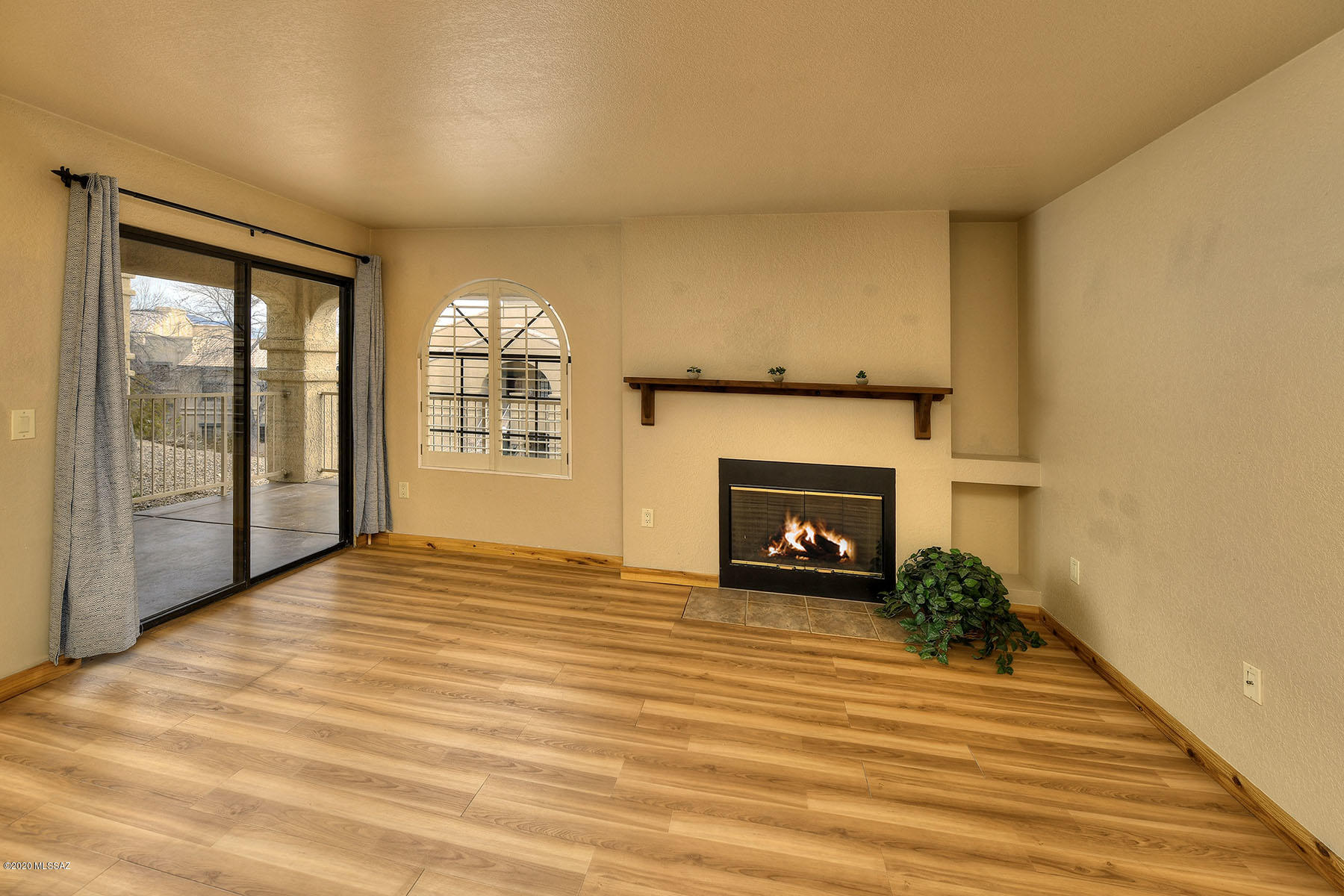 Very desirable 2 Bed/2 Bath ground floor condo located in the highly popular and peaceful desert setting of Moonrise at Starr Pass. Walk through the front door & you will see a cozy wood burning fireplace, spacious & functional floor plan, kitchen with granite counters & stainless steel appliances. Refrigerator, washer & dryer all convey.  Bedrooms are large & new carpeting in 2018. Enjoy entertaining on the large rear enclosed patio. Newer HVAC installed in 2018 - w/warranty.  Just minutes from downtown, campus & the airport. HOA includes: community pool, spa, fitness room, tennis, water, sewer, garbage, roof, exterior maintenance, exterior pest control as well as privileges at JW Marriott Resort. Rentals allowed. Please see Documents tab for more info. Move in today