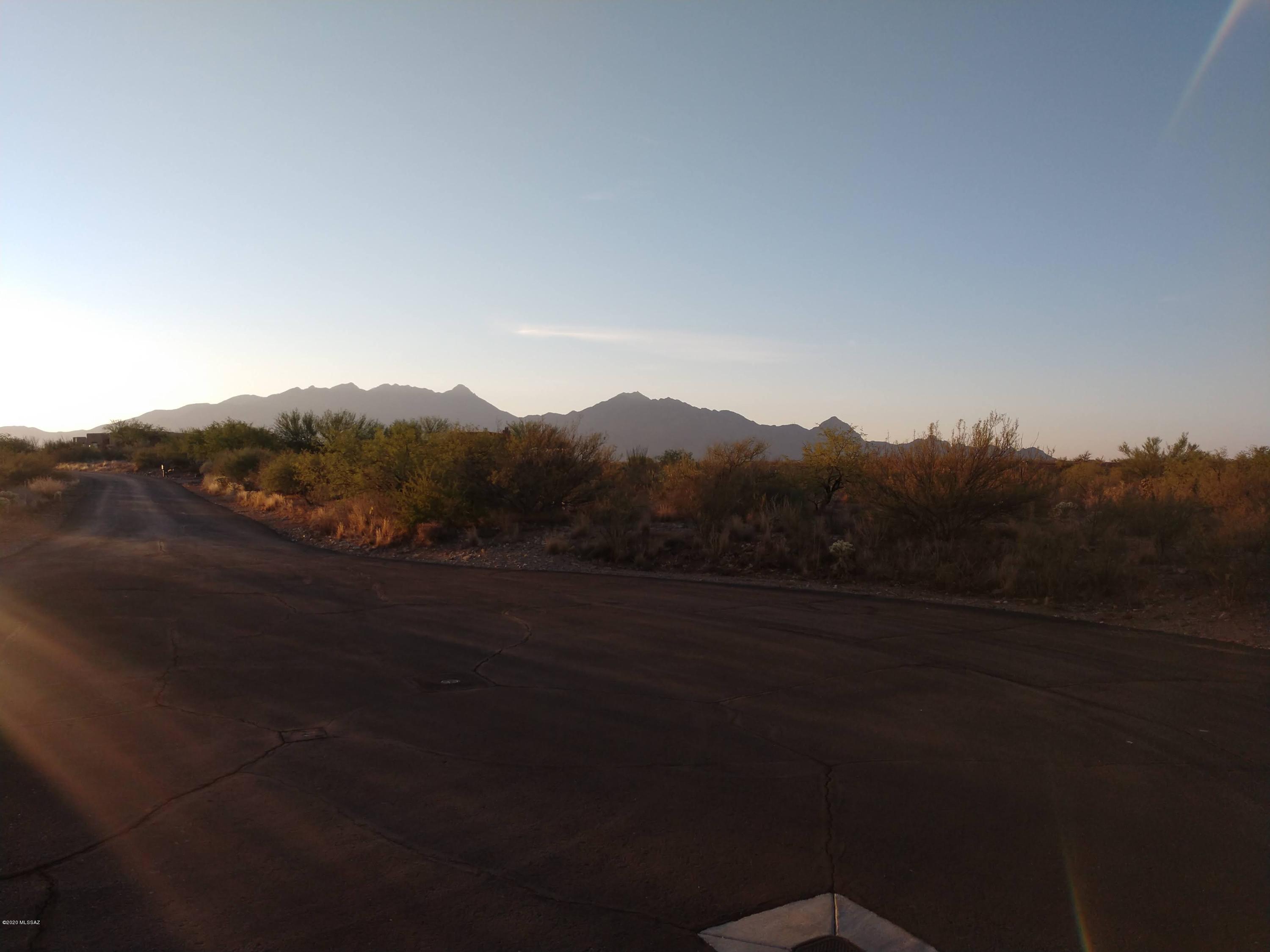 Choice custom-home site in desirable, gated Colonia Real subdivision.  Surrounded by no-two-alike custom built homes.  Beautiful views of the Santa Rita Mountains.  1/2 of lot is flat & 1/2 rolling.
