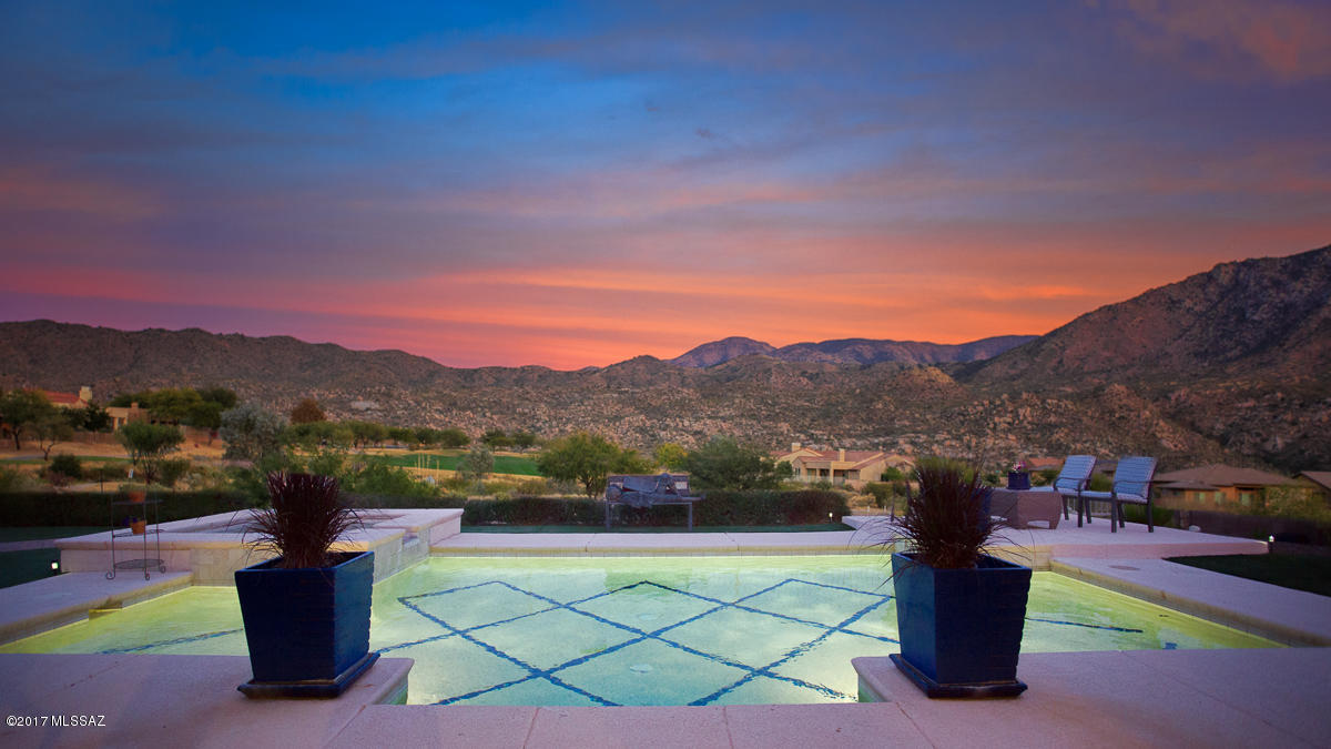 Luxury at its finest at The Preserve. This Sonoran model is on the 8th green of the Championship Preserve Golf Course with stunning views of the Catalina Mountains. Enter this private enclave into a lush courtyard & fountain. The large great room has a custom marble fireplace with a wall of glass looking out to the custom pool,and landscaping. Gourmet kitchen is a chef's delight. High end appliances, granite counters, custom backsplash and separate butler's pantry  No detail was spared by the owners. The spacious Master Bedroom has a spectacular ensuite with a walk-through shower, separate his & her areas, a garden tub & a huge walk-in closet. The main house also has a large den with built-ins & a media room. A separate guest house adjoins the courtyard. Must See!!