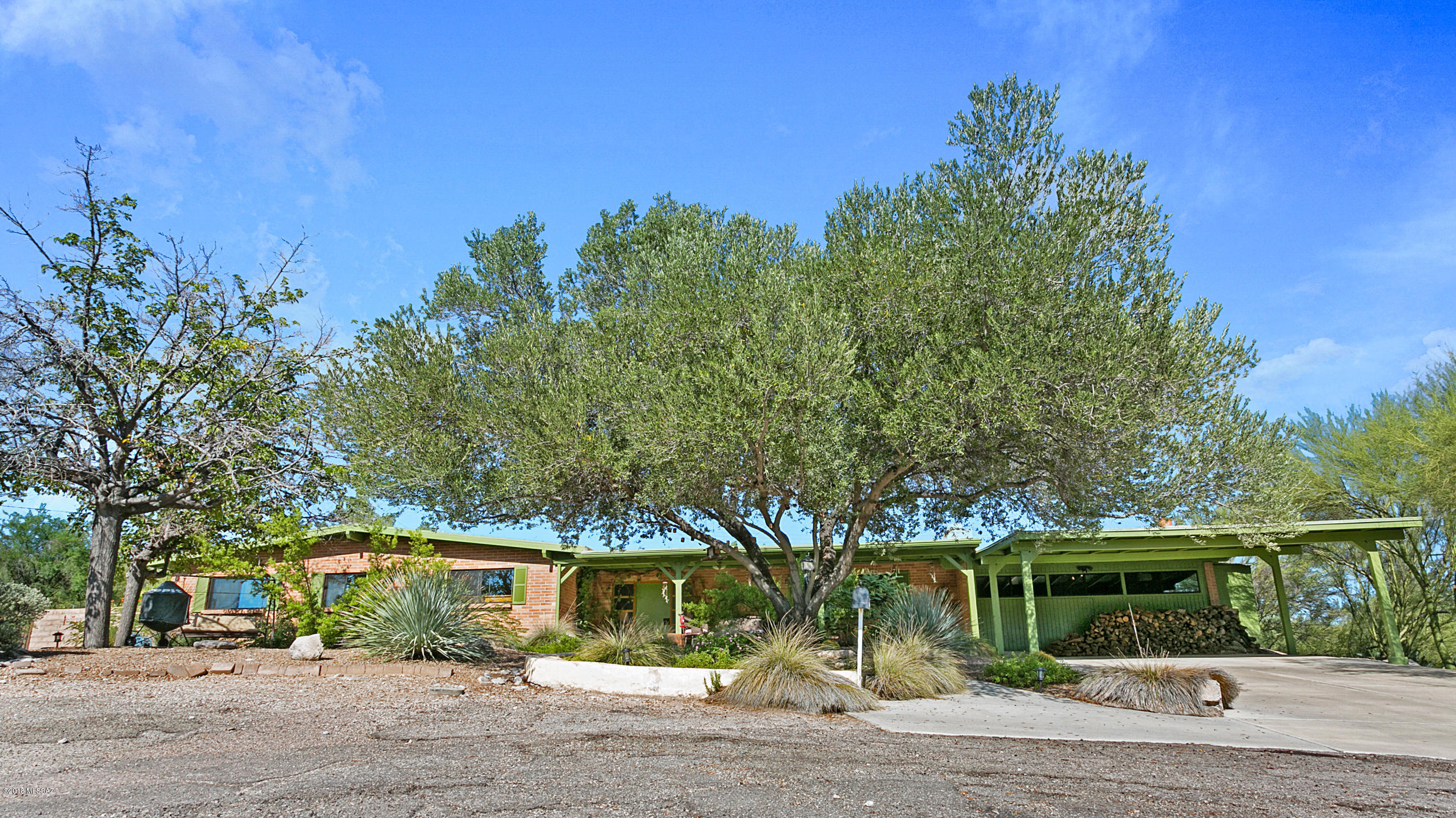 This home is truly a desert oasis!  Tucked away on a private cul-de-sac in the North Eastern Foothills, this mid-century charmer features lush mature growth that surrounds creating a private retreat.  Sit by the large pool and watch the color of the mountains change as the sun sets or enjoy the beautiful landscaping and city lights from the extended front porch.  Inside you will find two large living spaces each with wood burning fireplaces, a naturally lit kitchen with a gas range, and a formal dining space perfect for entertaining.  There are 3 nice sized bedrooms and a beautiful enclosed Arizona room surrounded by windows that allow for tons of natural light. All areas of the home are wheel chair.  To top it all off a new water heater and garbage disposal were recently installed! accessible.  Don't miss your opportunity to make this your new home! Schedule a showing today!