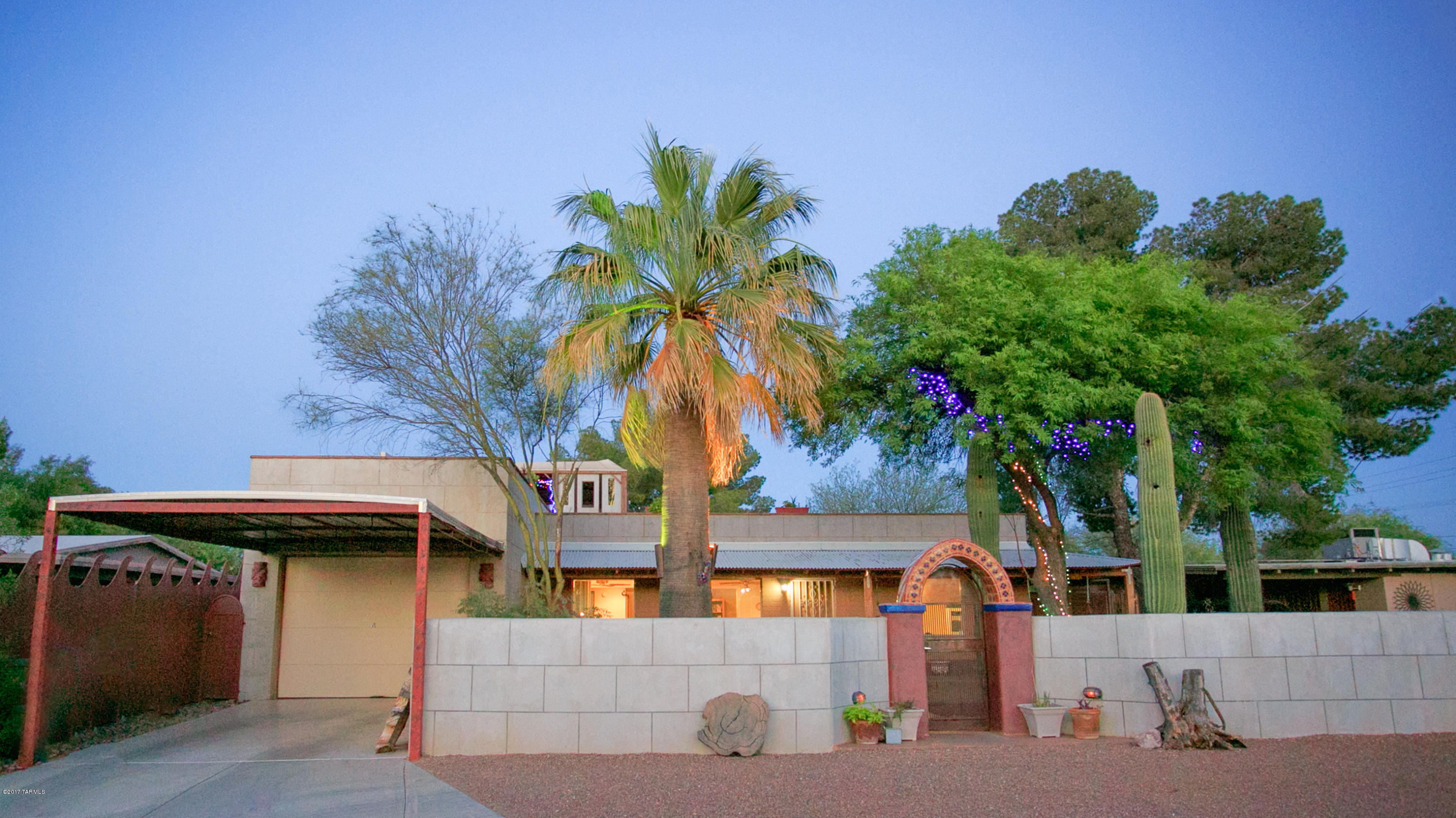 Look no further! This lovely 3 bedroom, 2 bath home with a STUDIO/OFFICE space (160 SF) is masterfully finished. Truly a one of a kind home with patios surrounding the home including atop the roof! Roof top deck is perfect for entertaining & delighting in the vistas of our mountains & Tucson's glorious sunsets! Master bathroom has a wonderful indoor/outdoor shower. Three generous sized bedrooms & lots of living space. Very smart, functional use of spaces throughout the home w/ lots of custom finishes. While there are elements of contemporary design, this home is charming, warm & very inviting. Open kitchen with custom  countertops & lots of storage space. Beautiful & custom concrete floors! Dynamic Central location! You will want to settle here & perhaps never leave! Truly turnkey!