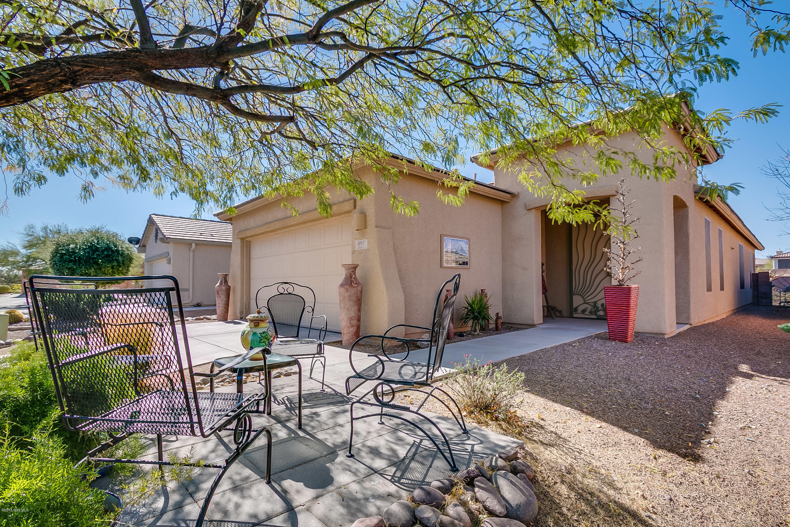 Beautiful Las Companas home with 1540 sq. ft. of living space, two bedrooms, two bathrooms and a den. The split bedroom floor plan offers all tile floors, lots of ceiling fans and attractive color scheme. The kitchen is open to the family room and features Corian counters, sleek black appliances and an attractive backsplash. The counter height breakfast bar is spacious and functional. The master bathroom has a shower with bench seating and grab bars. A convenient ramp leads to the screened in back patio and nicely landscaped backyard with extended block patio. Enjoy the front mountain view from the custom block patio in the shade of a mature tree. This well-maintained home is a must see!