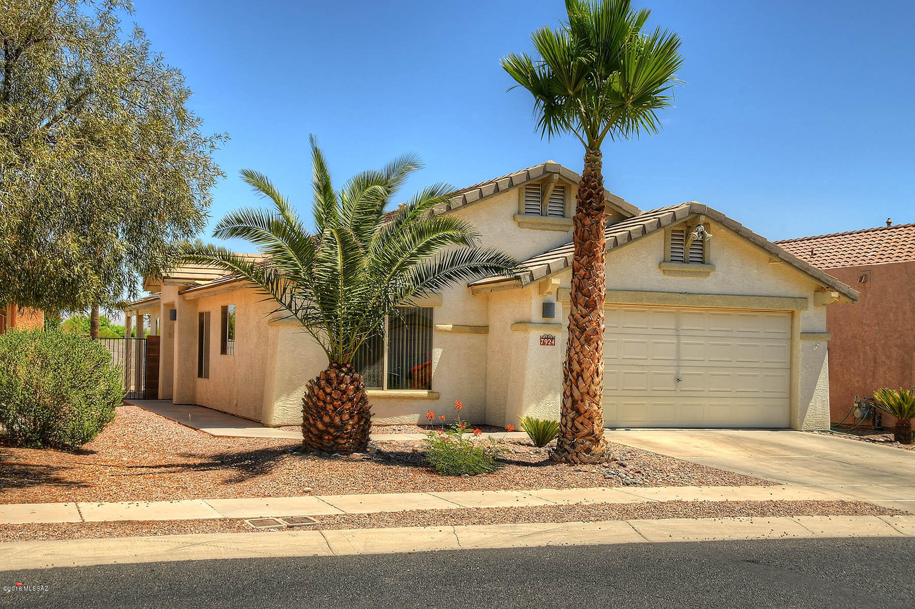 Fabulous well cared for house being offered by the original owner. Spacious, split bedroom floor plan, High, vaulted ceiling and beautiful Neutral tile that should go with any furnishings throughout the home. Wonderful split bedroom floor plan that feels larger than square footage. Spacious Great room is wired and has speakers left for surround sound already set up! Master bedroom w/very large walk-in closet walk in shower plus Tub.  Premium lot backs to the common area, with  a wash behind for extra Privacy!  Easy care Backyard features an elevated, ''spa/spool'' for relaxation and to enjoy the MNT views! Tall Block wall for privacy Plus a deep covered back patio w/metal lattice work (looks like wood) and custom brickwork. Can see the Mnt views over wall from Great Room, Master,& backyard