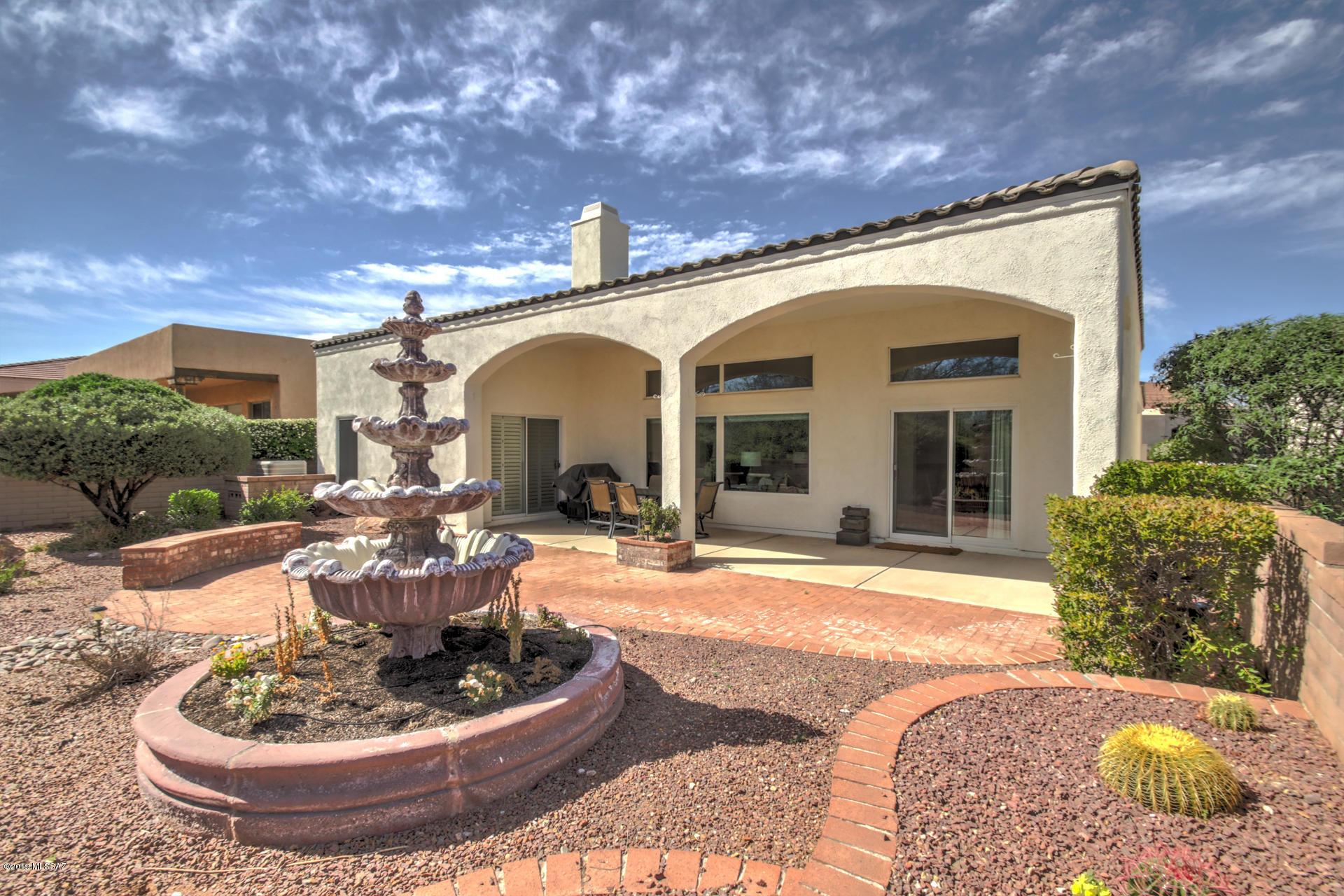 Tall arched entry and cascading tile roof lines present an impressive front to this 2BR and den Mediterranean style home of 2102sf in the gated Greens community. Solid, high quality construction by Green Valley's premier builder Dorn Homes. The interior showcases arched and picture windows, soaring 13ft ceilings, numerous plant shelves and niches, all blending into a distinctive open design. The large gourmet kitchen features black pearl granite, undermount composite sink, Stainless Steel appliances and counter space for several prep stations. Your guests can dine-in at the breakfast bar, nook or slip quietly onto the private rear patio soaking in mountain views and a wooded serenity. This home has been lovingly cared for. New HVAC, water heater, water softener, irrigation system, garage door controller- installed in the past 2 years. The Green's resident only pool and spa are within a block and the Clubhouse/Restaurant for Torres Blancas public golf course is just outside the Green's gate.