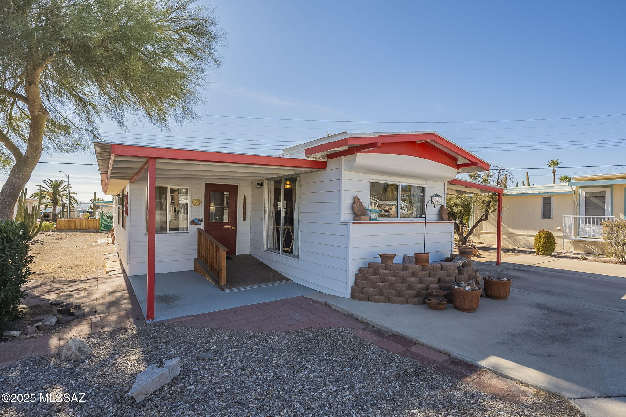 This 805-square-foot mobile home in Tucson Estates has one bedroom, two bathrooms, a family room, an office/den, and a sunroom with a 240 sq ft enclosed storage/workshop. This community has a pool, spa, pickleball courts, RV storage, and so much more. At this price, this house won't last!