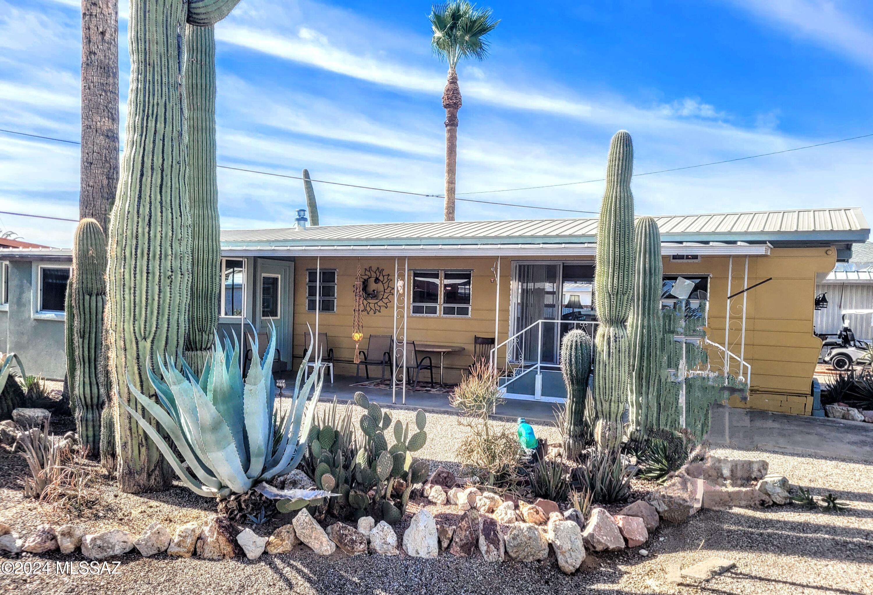 This charming home offers Resort 55+ living at an affordable price. You own the Land. Nestled in a serene setting, you'll enjoy breathtaking mountain views from inside and outside the home. The primary bedroom and en-suite bath are located in a newer stucco addition, providing a peaceful retreat. Stay comfortable year-round with central air conditioning. The laundry room is conveniently situated in a separate brick building. As a homeowner, you'll have access to a wealth of amenities, including free golf, tow sparkling pools, a relaxing spa, and courts for tennis and pickleball. This is more than just a home; it's a lifestyle!