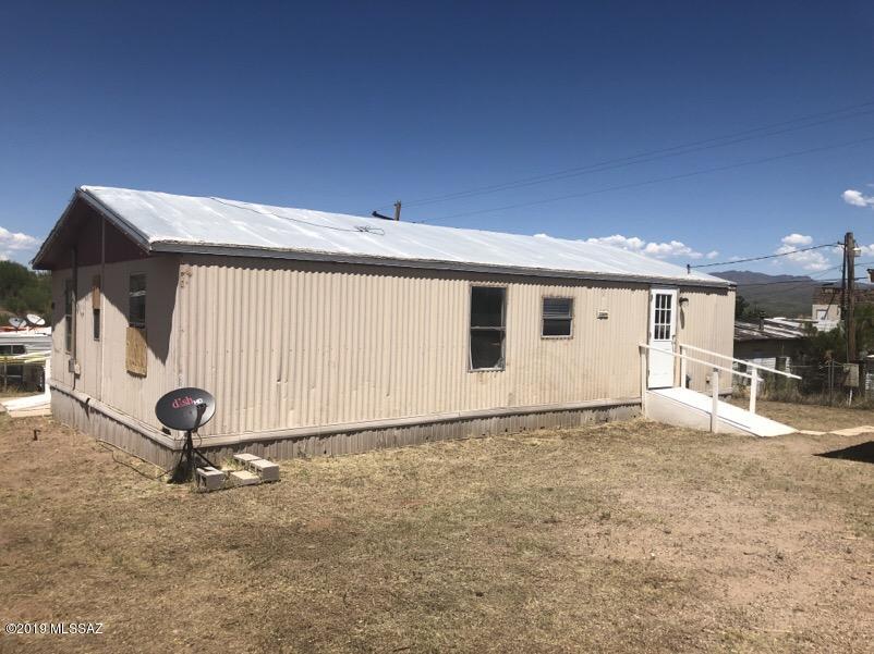 Double wide 1986 manufactured home on a .16 Ac lot with large outbuilding for storage or workshop * 3 bedroom, 2 bathrooms * Fenced yard for family or pets  * Property may qualify for Seller financing (VA Vendee), go to listings.vrmco.com and use the property ID# 120943 to determine if qualifies