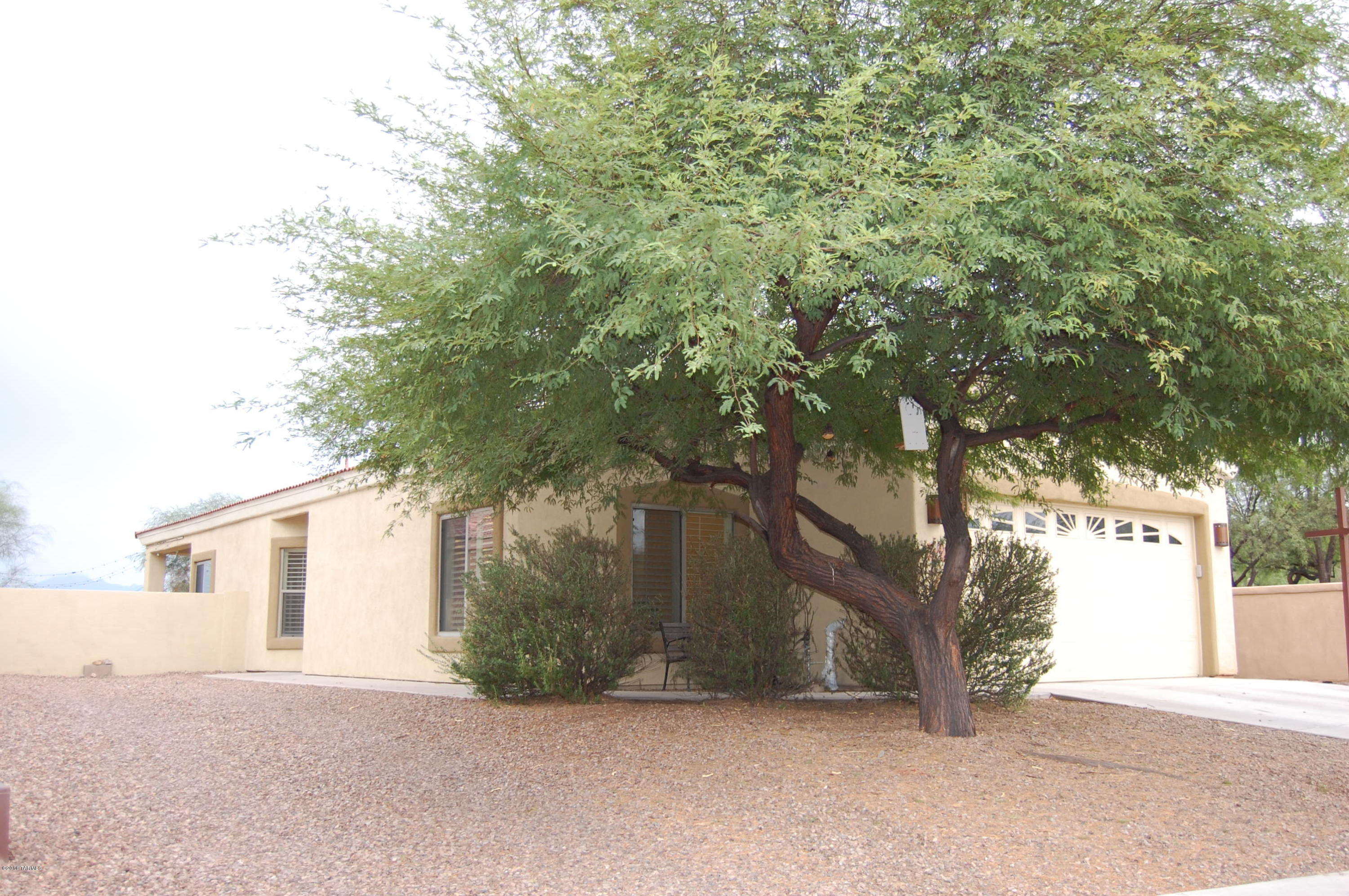 Perfect family home with many upgrades. This clean and beautiful 3 bedroom 2 bath home is located in the desirable Sahuarita community in a private cul de sac. Property backs into pecan grove and mountian views with no neighbors behind or on the left. 1 year old exterior paint and built in over-head racks in garage. Clean stainless steel appliances. Custom lighting, custom wooden shutters on every window.Beautiful tile throughout, granite counters,detailed back splashes. Pre-wired for alarm system.Pre-wired for smart home surround sound.This home boasts the largest yard in the neighborhood including a grill, turf and fire pit. Come See!