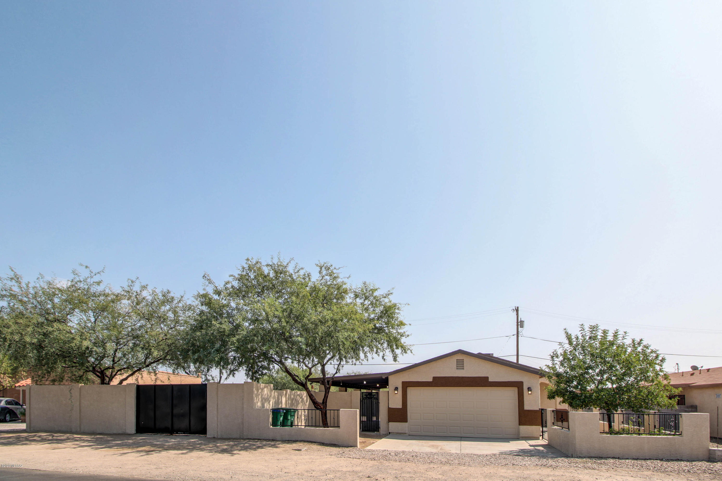 Great opportunity for a new style home on an amazing property!! This home sits on almost a quarter acre and has room to create a fenced-in OASIS or storage for ANYTHING you may need! Extended covered patio has plenty room for anyone's needs!  Double gate in the front for easy entrance/exit access and privacy wall all the way around! View wall around the entrance side of the property gives this home a great accent and provides subtle enclosure! The interior is move in ready with fresh looking stained floors throughout and upgraded cabinetry in kitchen and bathrooms. This property will truly not disappoint you!!