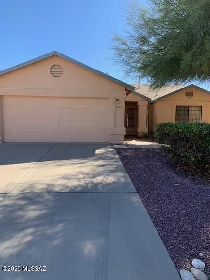 Here it is the one you have been waiting for.  Popular high scoring Vail schools.  Close to DM Air Force base, Shopping, schools, Restaurants, two neighborhood parks, and I-10 freeway.  Take a look at this back yard !! lots of room very low care.  Beautiful brick path and patio in back yard.  Appliances including washer and dryer.  Home has a water conditioner. Cozy  wood burning fireplace in living room.   All clean and ready for their new owners.  Extra parking pad on side of garage.  Sorry no permanent RV allowed.  Don't let this one get by it will not last.