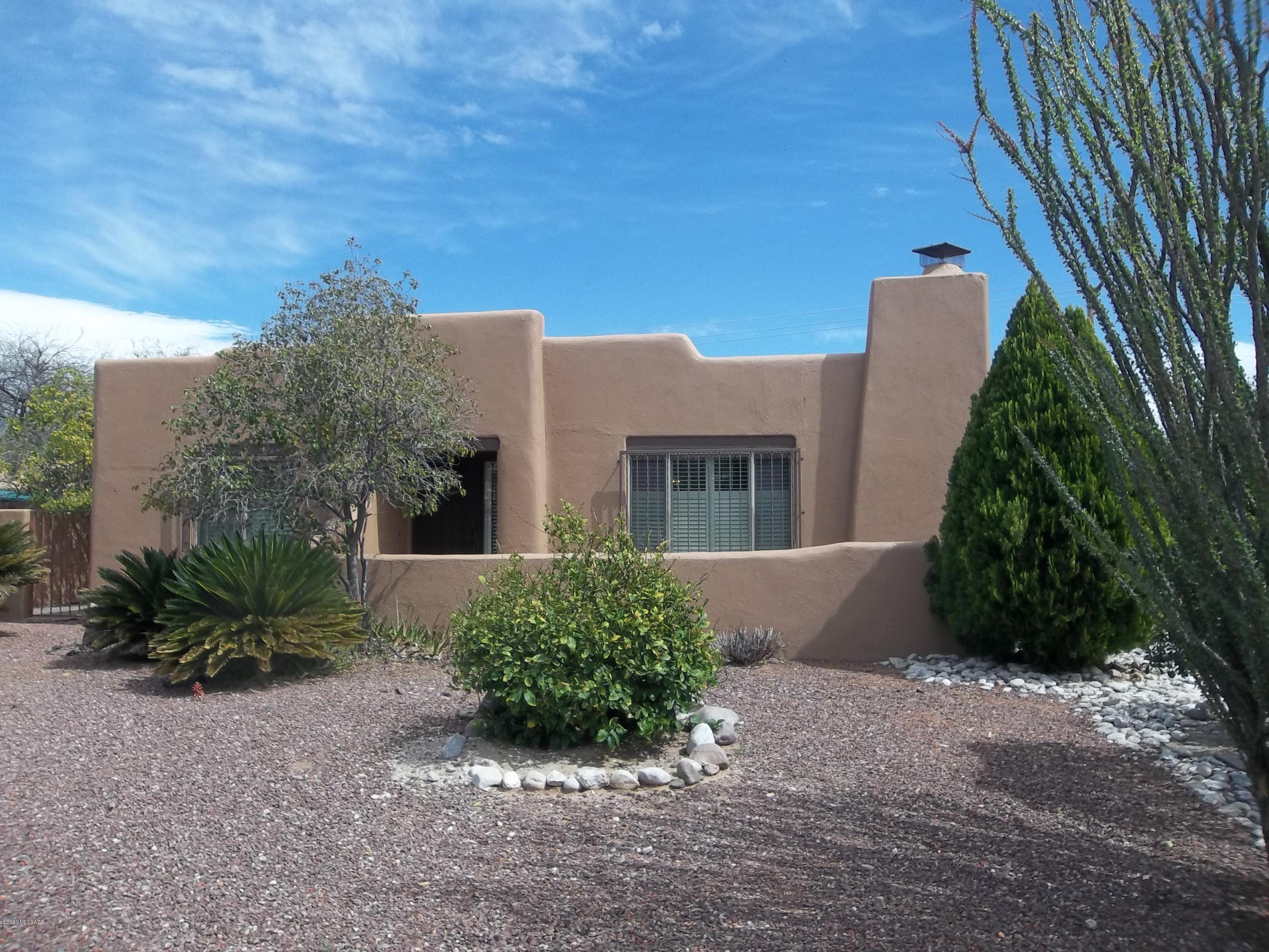 Must see this great sparkling home in desirable Pueblo style, private 44 home subdivision. 3 BR, 2 BA, light and bright floor plan with beehive fireplace, tile throughout, plantation wood shutters. Ceiling fans in every room. Skylights add to light and comfortable living. Light, spacious kitchen with walk-in pantry. Remodeled bathrooms, one with walk-outside drying area. Expanded walk-in master bedroom closet, unique for neighborhood. 2 car garage with built-in storage and cabinets. Screened in back porch with matching stucco walls offers nice outside entertaining. Finished backyard with artificial grass, slate, flagstone and storage shed. Gated side yard for great dog run. Close to Trader Joes, river walk and great route down Mountain Ave to UofA. Listing agent is related to the seller.