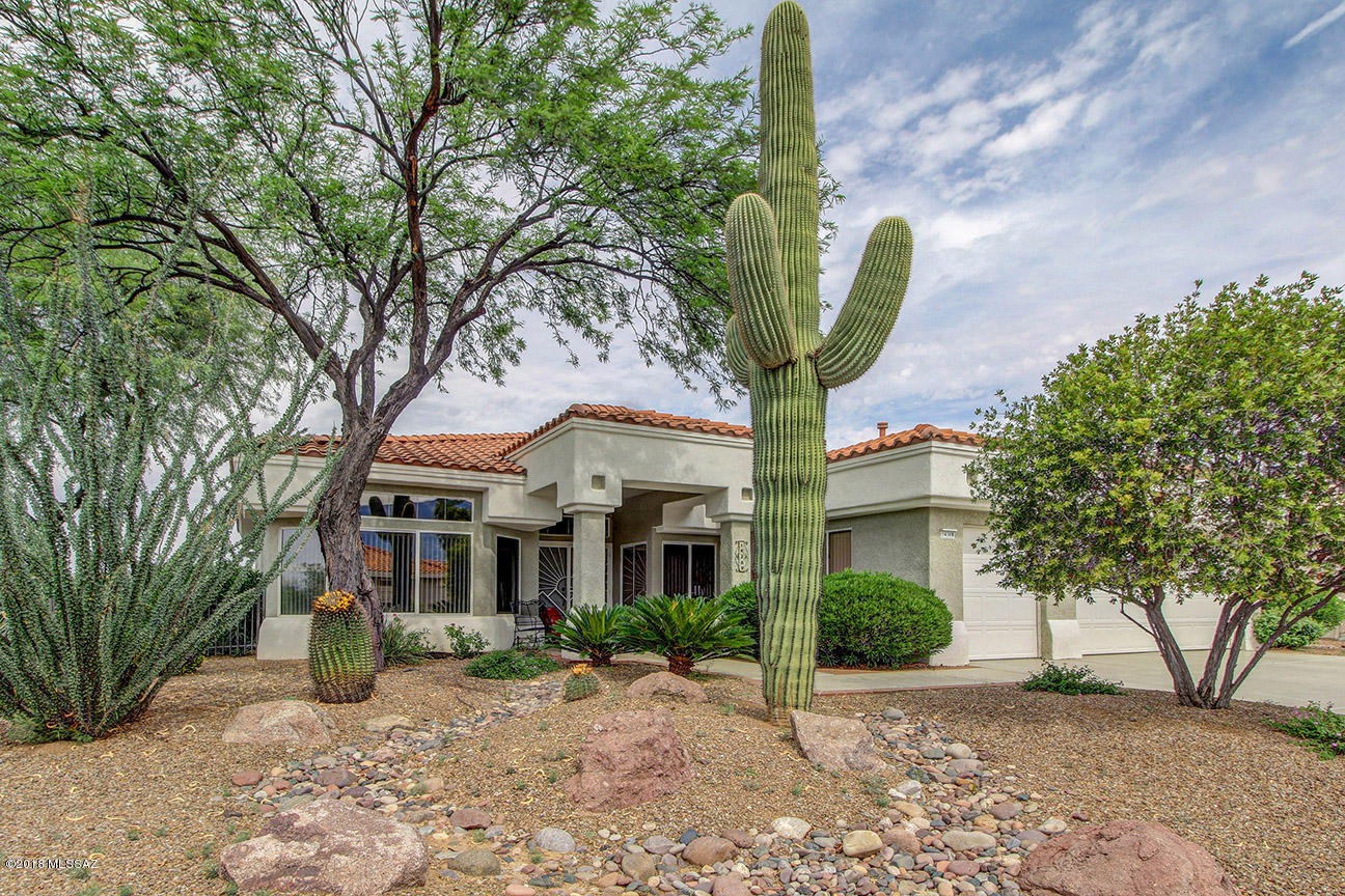 Rare Ridgetop Model with over $50,000 in improvements and upgrades. Bright and happy home featuring views of the Catalina's as well as the Tortolita Mountains bordering a large common wash. Improvements include new 16 Seer Lennox HVAC, New appliances, washer/dryer, wonderful upgraded Master Bath/Shower, Remote controlled Sun Shades on the expanded back patio Ramada, Enhanced space with Classy Closet Built Ins, Solar Tubes. Tons of extra storage cabinets in the 2 car+golf cart garage with added lighting.