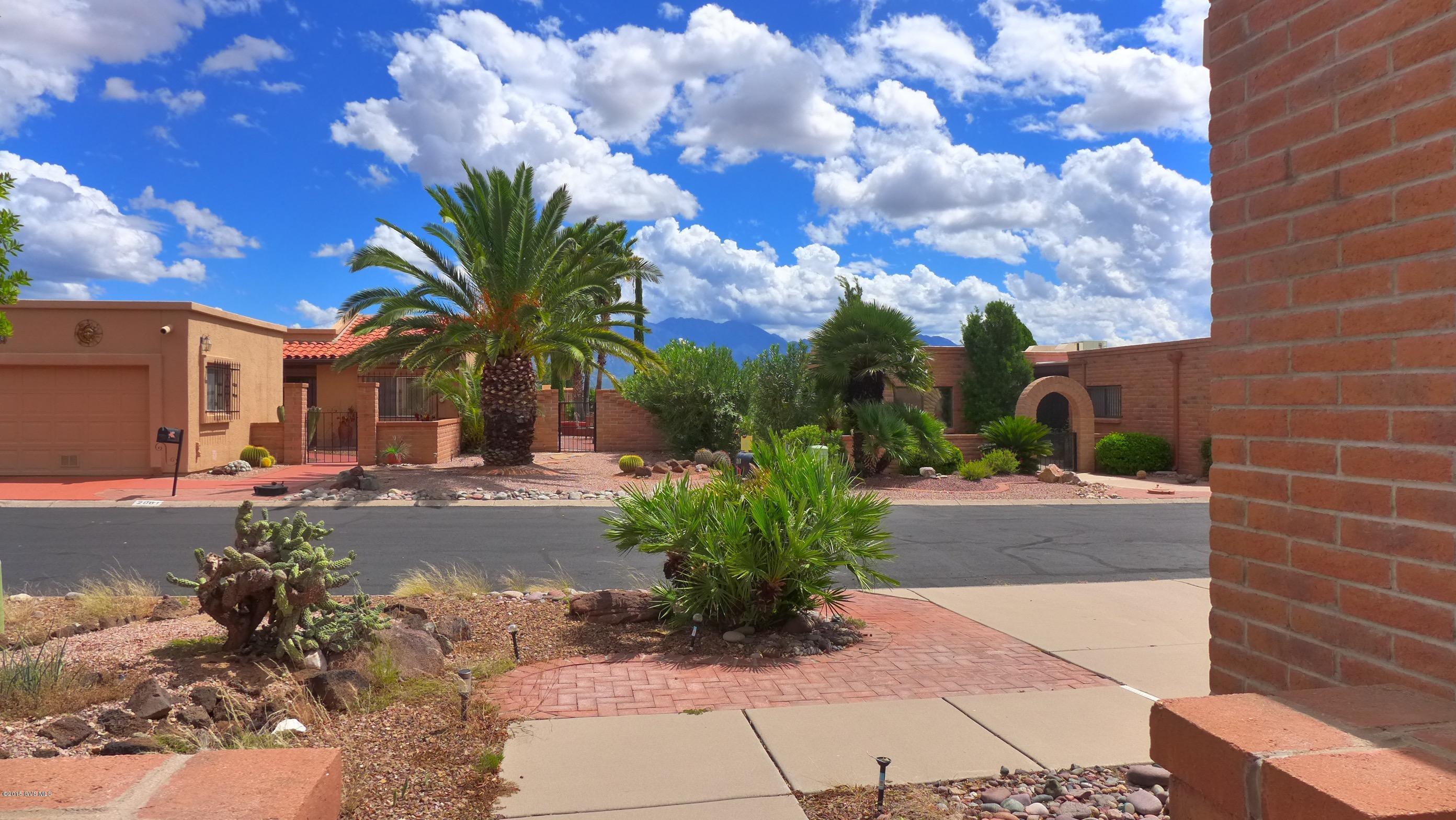On your way inside the house, stop a moment to enjoy the beautiful view of the mountains from the front courtyard. Inside you'll find a freshly painted interior and new carpet in the living/dining room & both bedrooms. This budget friendly home has a large living/dining room with a sliding glass door that leads to the AZ room; and a spacious kitchen with a large eat-in area. There is a wall bed in the guest bedroom that conveys with the home. Low care landscaping means you'll have plenty of time to enjoy all the amenities that Green Valley offers.