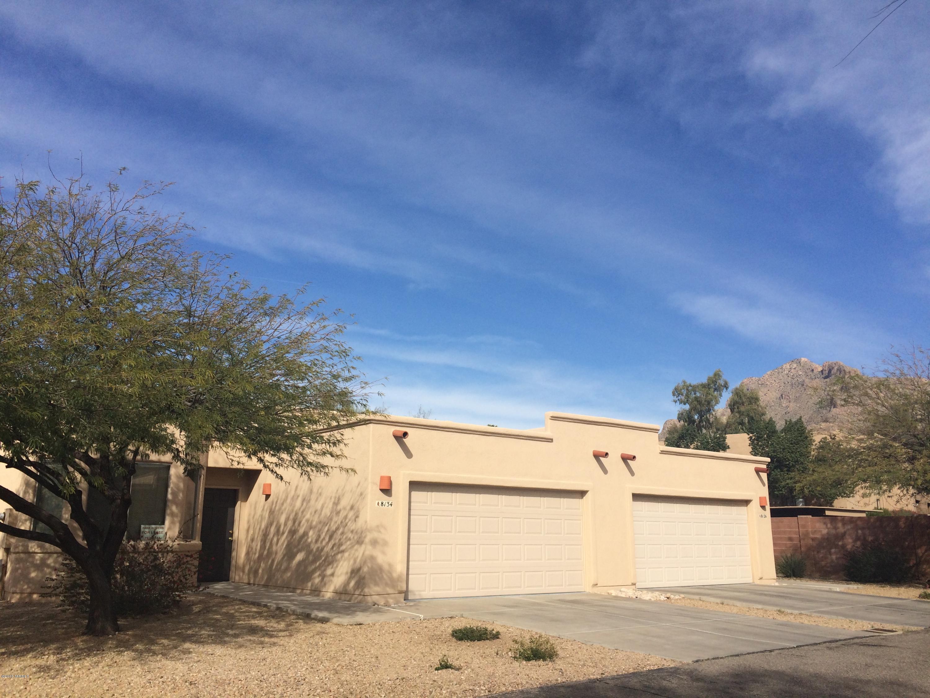 This beautiful 3 bedroom 2 bathroom townhouse has a great open layout. High ceilings, Southwestern architecture with views of the Santa Catalina Mountains. Two car garage. It has Italian tile, Berber carpet and a fireplace. AC and ceiling fans throughout the place, with skylights inside and in the garage. Covered porch with enclosed backyard. All appliances that include a refrigerator with ice maker, self cleaning oven, and a built-in microwave. In Amphitheater school district. Must see!