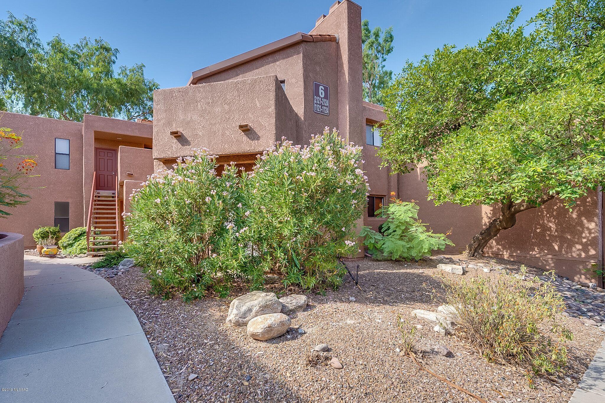 Ground floor resort style condo features an open floor plan with a split bedroom layout. A wood burning fireplace in the Great Room with zoned heating and cooling. The kitchen has Corian countertops and white appliances. Spacious Master Bedroom with a walk-in closet and dual sinks in the Master Bathroom. The Ventana Condos include a heated pool and two spas, spacious clubhouse with library, tv, pool table and full kitchen, exercise facility, tennis/pickle ball court, bbq grills on site on approx. 20 acres. community is located near shopping, restaurants and Sabino Canyon Recreation Area.