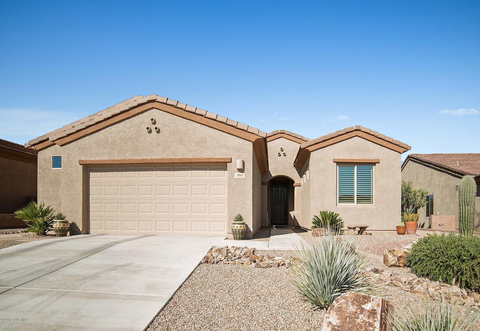 This immaculate home with warm colors will make you feel right at home. You'll enter this home into an open great room with curved wall architecture and you will also notice the attractive diagonal floor tile throughout allowing for super easy care. The cook's kitchen has staggered rich hardwood cabinetry, counter tops sheathed in solid granite with designer tile backsplash, serving bar with custom pendant lighting and a gas range. Your quiet master bedroom suite offers a spacious bath with a clear glass shower enclosure, dual sinks and a custom framed mirror. The split bedroom arrangement will provide lots of privacy for your family and friends. Step outdoors to find easy care landscaping with river rock gardens displaying numerous cacti species and fanning palms. Enjoy relaxing on  your shady covered patio where you can kick back and enjoy vast miles of natural desert views.