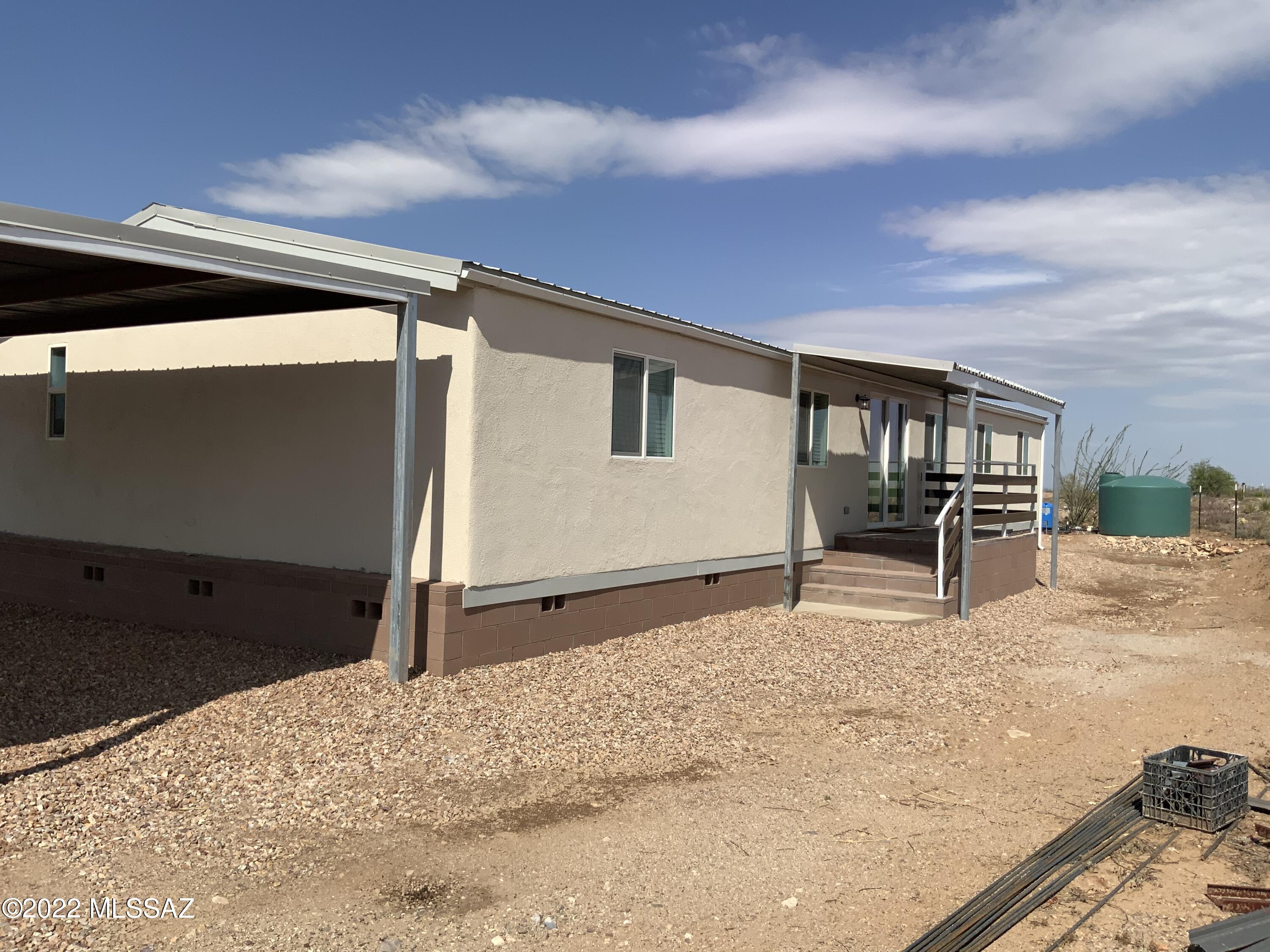 REDUCED $20,000 Beautiful high desert property at 1.21 acre. Fully fenced lot. Large double carport. Solid Block Skirting for trouble free support. This home has a great open Floor plan. The bedrooms are generous with great closet space. The home has a trouble free Metal Roof. Lovely Granite Counter tops. Laminate wood flooring throughout. Has hauled water only into the 1500 Gallon Water Storage tank. New 5 ton Air Conditioner to keep you cool in the summer. Step outside into the oversized yard that has plenty of space to make it your own backyard paradise. Seller financing possible with a substantial down payment. Twenty Five percent down payment minimum. Subject to the buyers credit rating. Make this your dream home.
