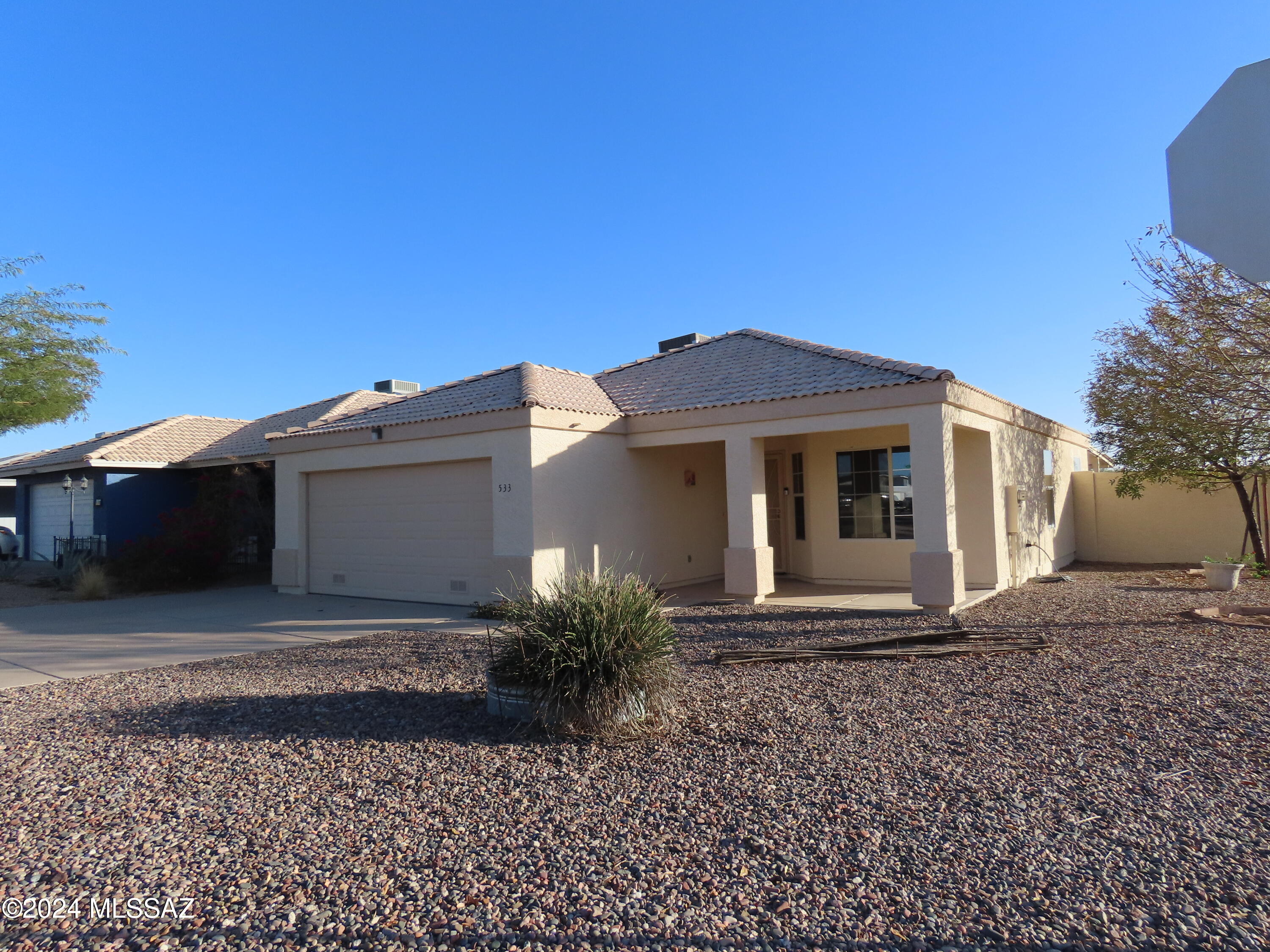 An affordable family home, perfect for year-round living or a winter home. Not an age restricted community.  Open floorplan, great room concept, Eat-in kitchen plus a dining area. 2 primary bedrooms each with a bath, one with large walk-in closet. Tile floors throughout. Wonderful extended covered patio, for  enjoying the outdoors.  Easy low care front and rear yards. A bonus is a RV gate offers room for boat or RV. Extra tall block wall in rear. Freshly painted interior and exterior. 2 car garage has built-in storage cabinets & exterior storage shed.  Great curb appeal with tile roof. Private feeling corner lot. Desirable community with pool and  meeting room, low monthly HOA dues. Extremely convenient to shopping centers.  Located near Central   Arizona College campus at Broadway/Idaho