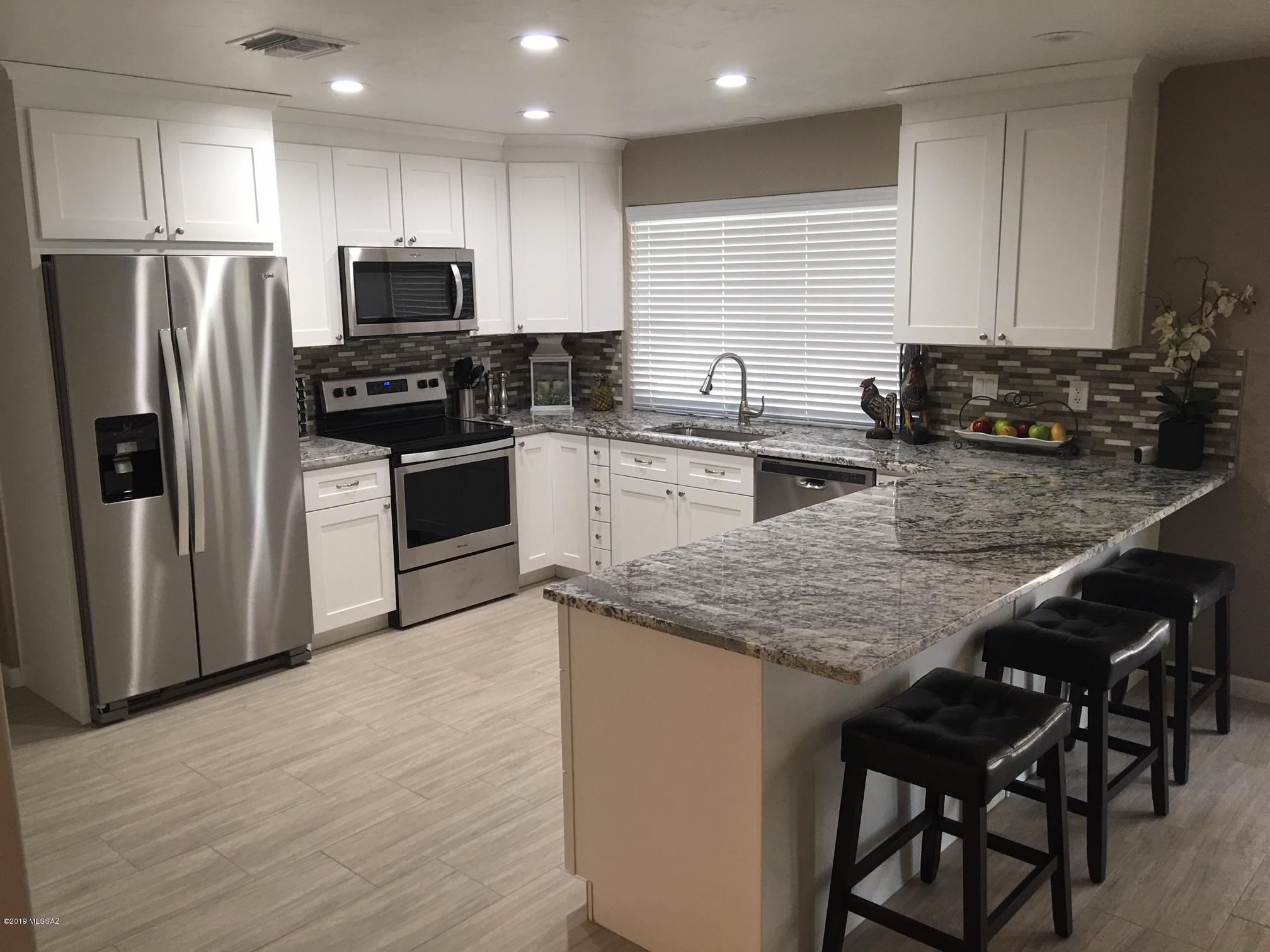 Completely Remodeled Home with Pool and Spa.  New Granite in kitchen and in both bathrooms, New AC, New Roof Shingles, New Stainless Appliances, New Cabinets, New tile flooring, New Carpet in all Bedrooms, New paint,  New light fixtures, New Ceiling fans, New pool tiles, and much more.  Two car garage plus a 8' X16' workshop/storage room.  NO HOA's Must See