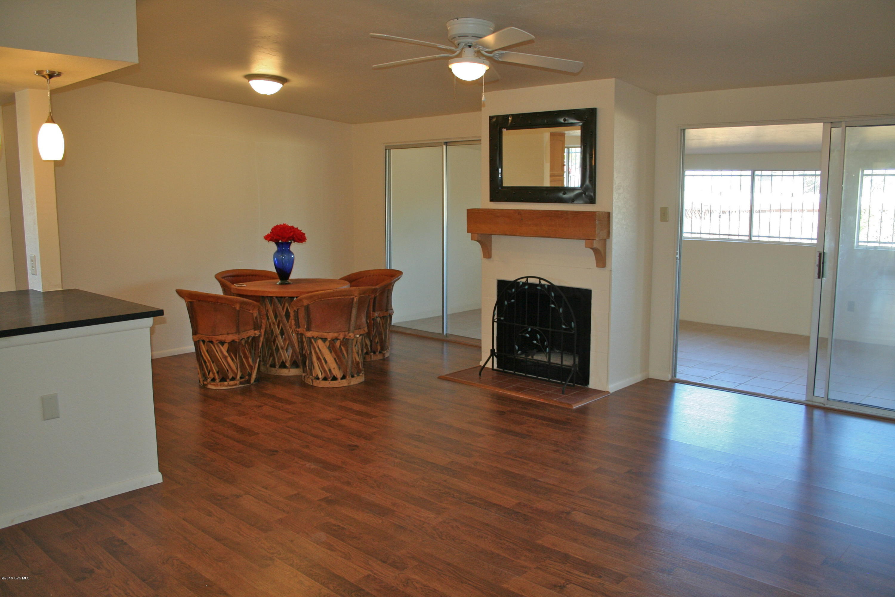 Fully remodeled single family home with captivating Santa Rita mountain Views! Enter into the great room where the mountain views are evident from every angle. This large open living space exudes warmth from the new wood floors and wood burning fireplace. The kitchen is open to the great room and dining area, and has elegant charcoal soapstone counters, pendant light fixtures and new appliancss. The bathrooms have been updated with new tile, new light fixtures and new countertops. The master suite looks out to the mountains and has a beautiful new tiled walk in shower. There are two extra bedrooms, one for your winter guests and one for you den or media room! the arizona room is lined with windows looking out to the mountains, and is perfect for entertaining or just relaxing with a  book. The east facing back yard deck is lovely and peaceful and has an amazing mature orange tree to go along with your BB-Q and the views! The home has been recently painted, both inside and out, and has new toilets and plumbing fixtures. Add on a 2 car garage and you wont find a more beautiful, turn key home with this much space and this many upgrades in all of Green Valley!