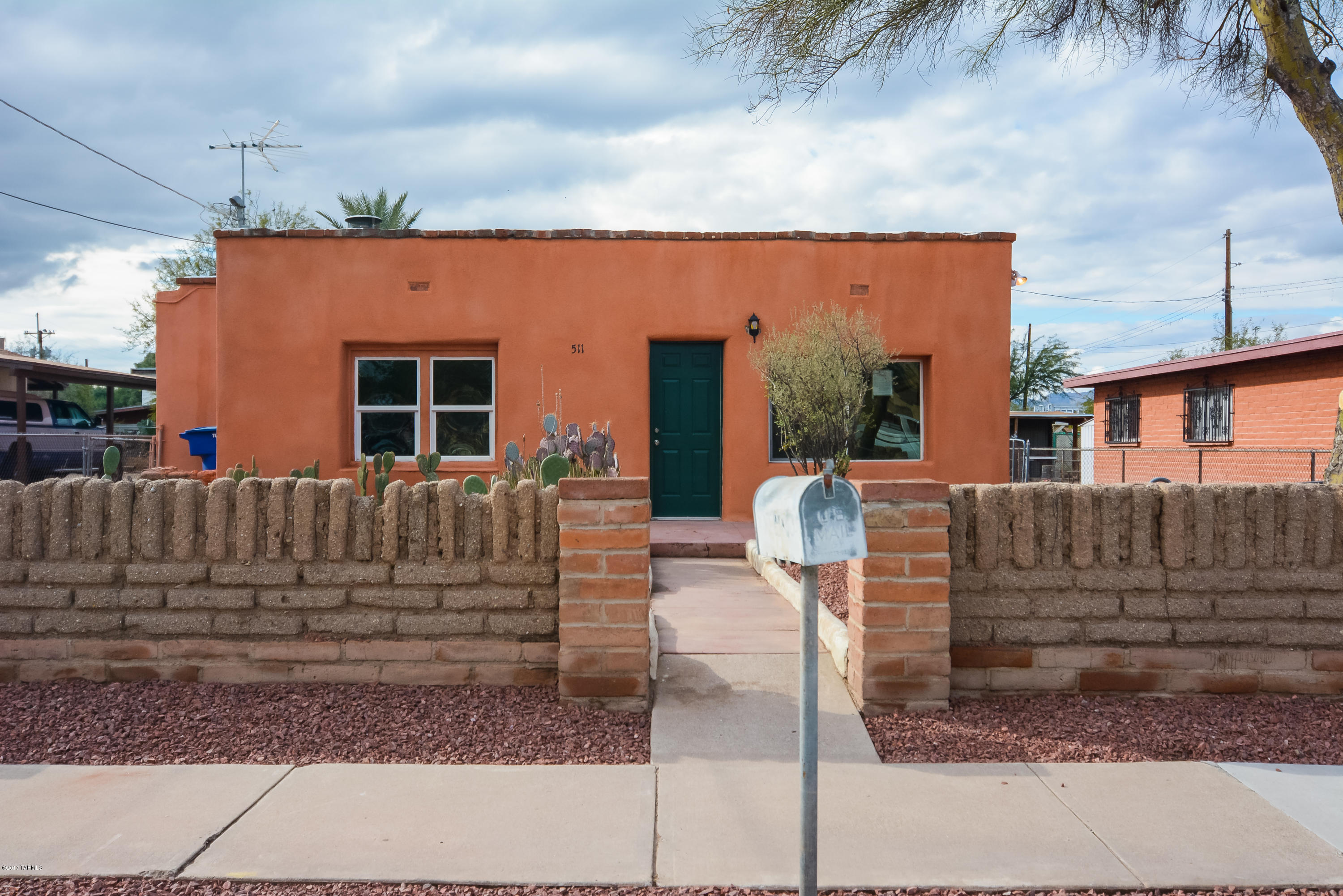 Beautifully remodeled territorial style home. Located in a highly desirable Tucson location. Charming southwestern architecture. Rich dark wood laminate floors. Nice modern kitchen with stainless steel appliances. Granite counter tops. Modern tile back splash. New custom interior and exterior paint. New upgraded carpet in bedrooms. Rustic brick fireplace in living room and one bedroom. Modern master bathroom with custom master bathroom shower.Nice back yard with storage room. Mature trees. Professionally landscaped yard. Upgraded door hardware and light fixtures. This home shows beautifully.