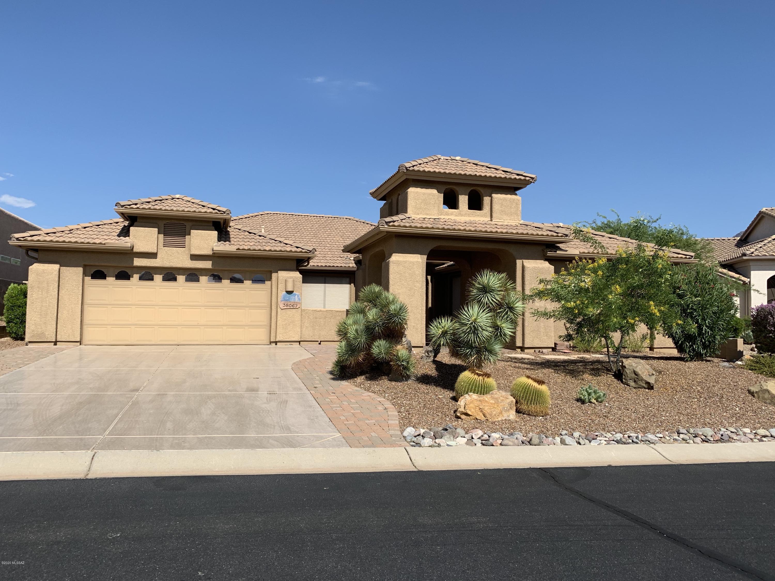 Enjoy Arizona retirement living at its best in one of Arizona's premier retirement communities.   This property has an EAST FACING BACKYARD WITH MOUNTAIN VIEWS (no neighbors behind!); built-in grill; extended under cover patio plus lovely paver extension makes entertaining a delight.  Inside find rooms with a view... master bedroom, family room, kitchen (and eating area) and the living room all have a mountain view.  Master bedroom is generously sized with walk-in closet and a spare!    Split bedroom plan allows your guests (and you!) privacy.    Den/office with a wall of built-ins.  Two car garage plus the golf cart garage.  There is built-in storage in the main garage.  Come enjoy life in the wonderful neighborhood of Saddlebooke  with all its amenities.   It's just the thing for you!