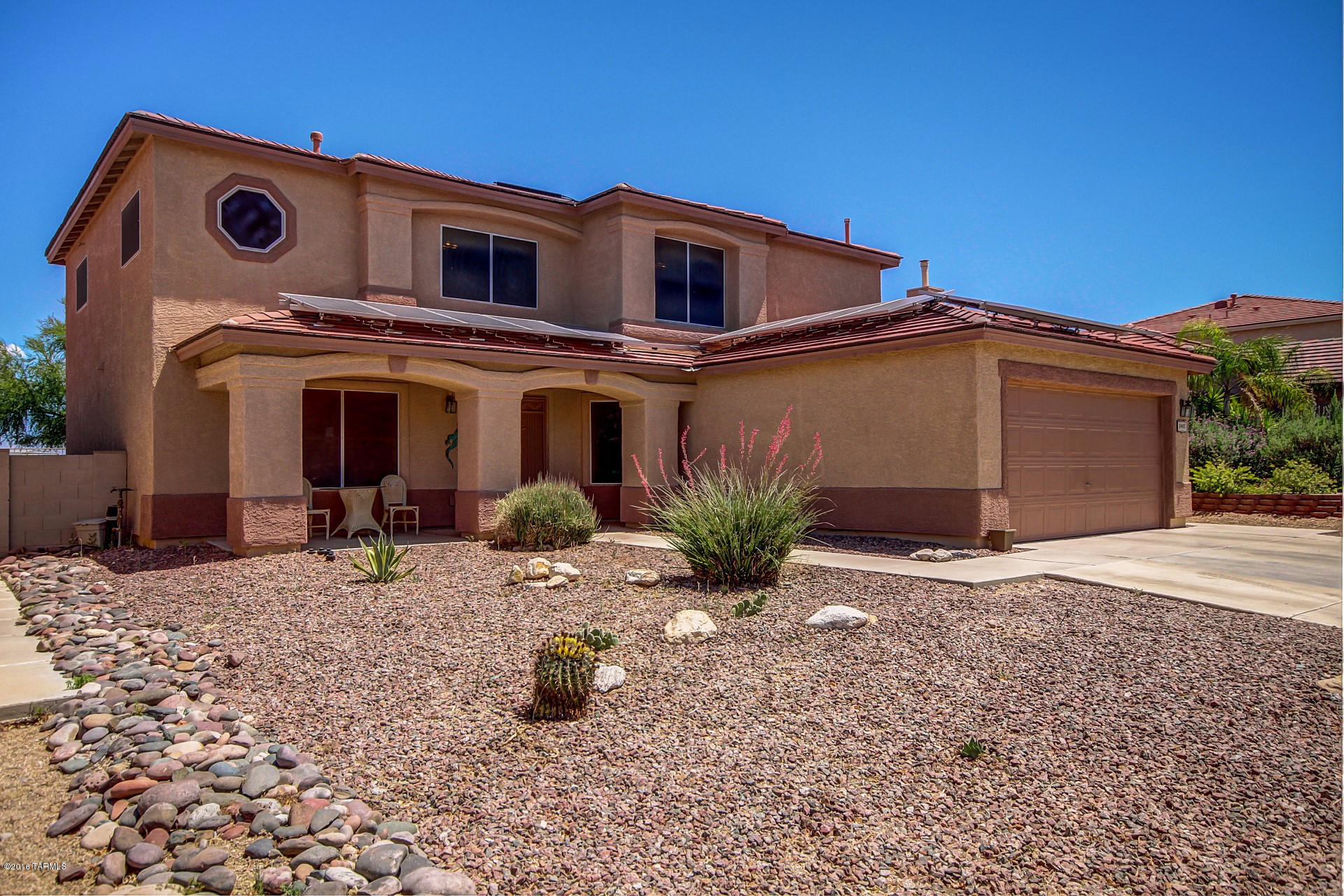 Majestic Mountain Views! Welcome to the Community of Rita Ranch. Fantastic Energy Efficient Solar Home. Gorgeous interior with custom palette, tile floor, window blinds, upgraded lighting, and spacious open floor plan. Cozy fireplace, ceiling fans, Arcadia Doors to patio, plant shelves, and plush neutral carpet in all the right places. Spacious open kitchen features center island, tiled counters, white appliances, and wood cabinetry. Guest bedroom and bathroom on first level perfect for in-laws. Amazing loft area with endless possibilities. Grand master retreat with private balcony and private en suite. Enjoy the backyard covered patio, refreshing fenced pool with gas heater, above ground spa, and Mountain Views. $50,000 solar panel upgrade! Solar OWNED - Not Leased!! A must see this home!